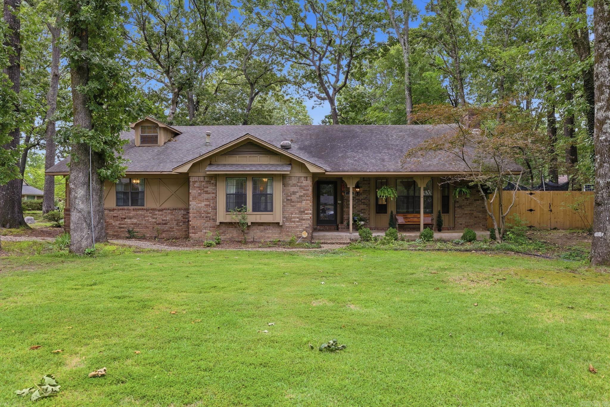 Welcome to 1330 Salem Rd in Conway! This 4BR/2BA brick home sits on a beautiful 1/3-acre lot with mature trees and features a large fenced backyard and incredible wrap-around deck. Inside, you’ll love the soaring 20-foot ceiling in the living room and the dramatic floor-to-ceiling gas-start fireplace. The spacious kitchen offers gorgeous cabinetry, custom vent hood, and brick tile backsplash. Three bedrooms are located downstairs, with a large loft-style fourth bedroom upstairs. Recent updates include HVAC (2023), flooring (2023), plumbing upgraded from clay to PVC (2024), deck (2024), fence (2025), stove (2025), dishwasher (2025), plus a new roof being installed. Move-in ready with character, space, and major updates already completed!