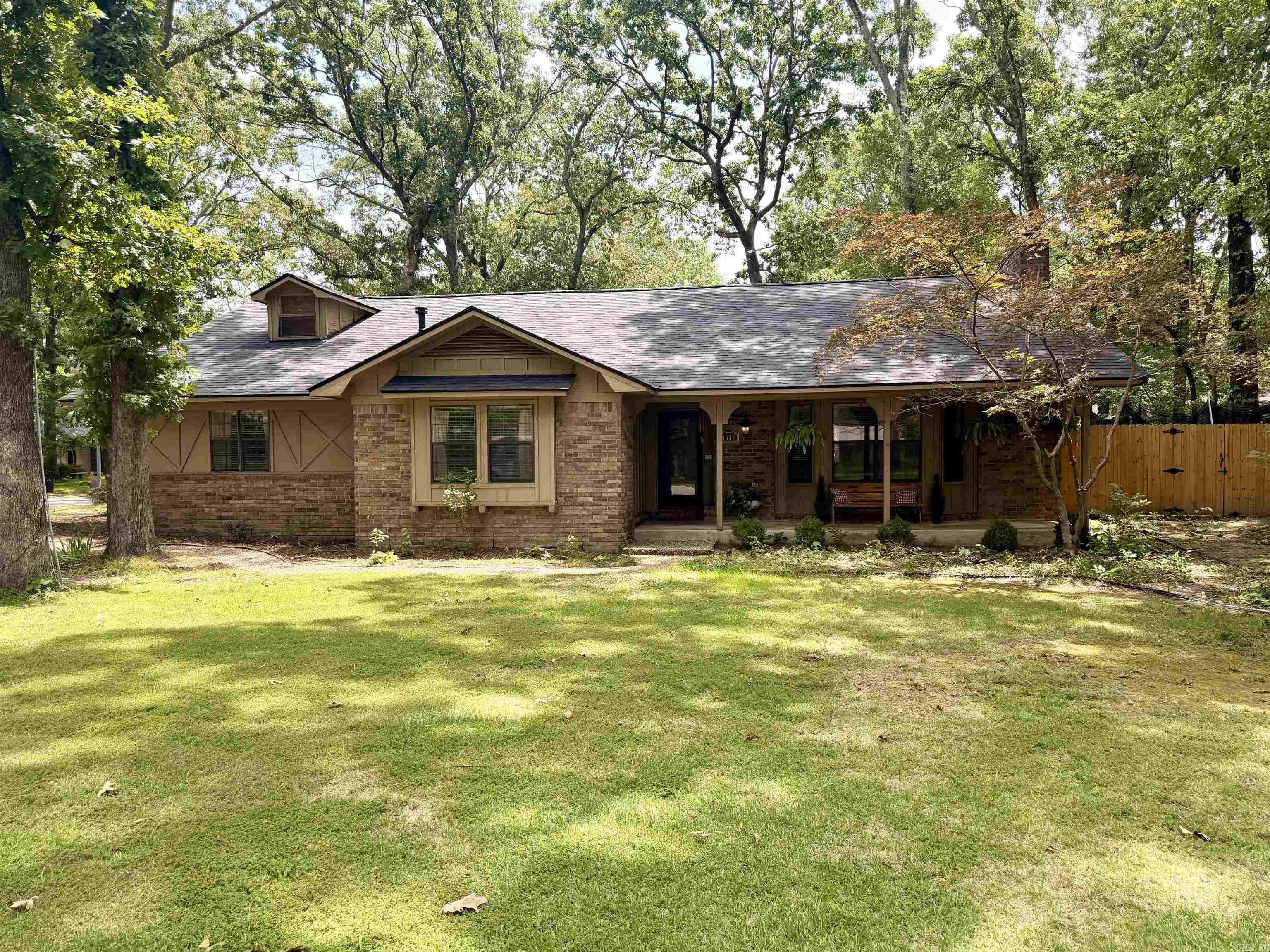 Welcome to 1330 Salem Rd in Conway! This 4BR/2BA brick home sits on a beautiful 1/3-acre lot with mature trees and features a large fenced backyard and incredible wrap-around deck. Inside, you’ll love the soaring 20-foot ceiling in the living room and the dramatic floor-to-ceiling gas-start fireplace. The spacious kitchen offers gorgeous cabinetry, custom vent hood, and brick tile backsplash. Three bedrooms are located downstairs, with a large loft-style fourth bedroom upstairs. Recent updates include NEW ROOF (2026), HVAC (2023), flooring (2023), plumbing upgraded from clay to PVC (2024), deck (2024), fence (2025), stove (2025), dishwasher (2025). Move-in ready with character, space, and major updates already completed!