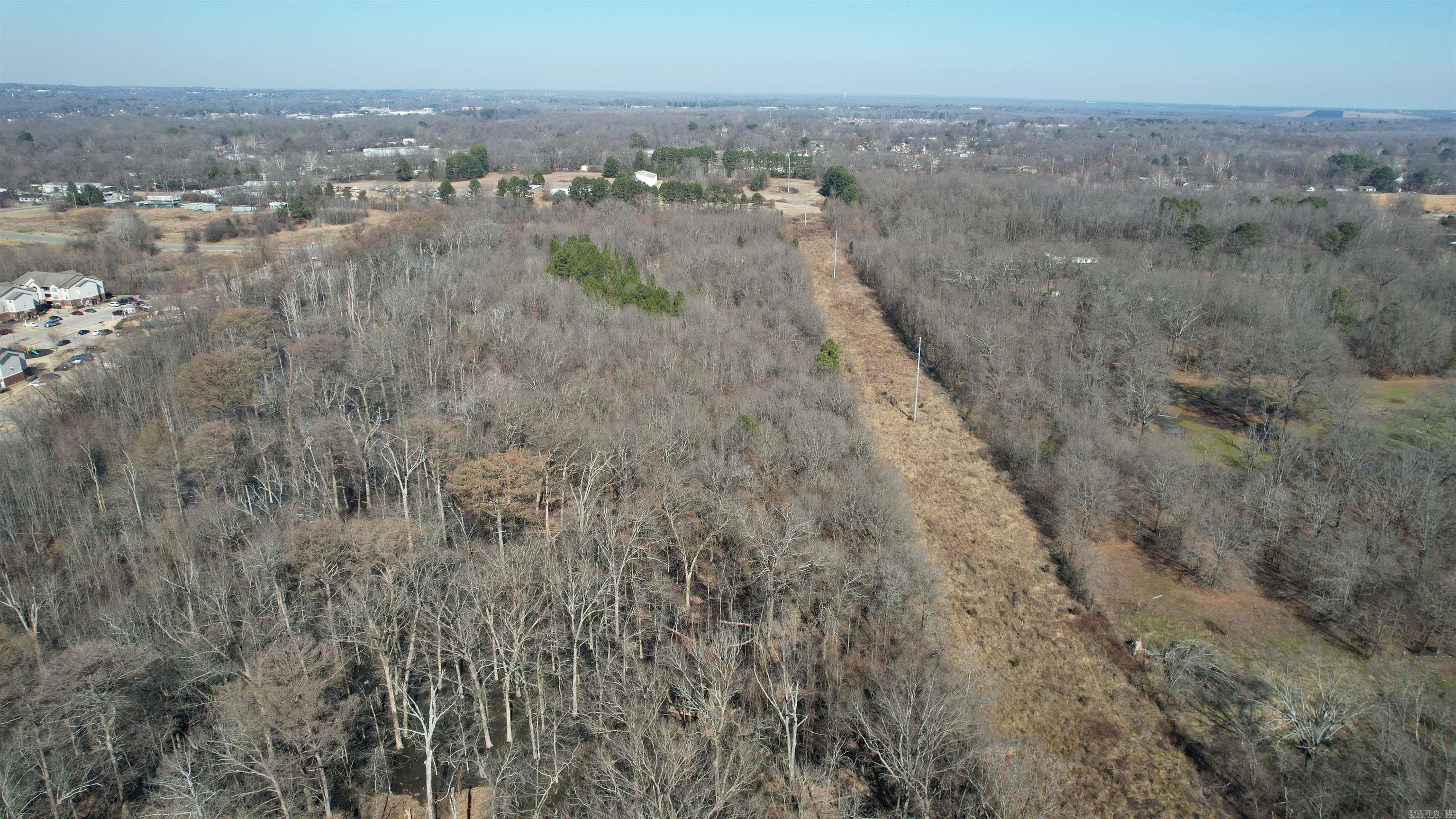 Tucked away at the end of a quiet road in the McAlmont community, this 22 ± acre property offers a rare opportunity to enjoy privacy and space while remaining inside the city limits of Pulaski County. Surrounded by well-kept homes and attractive neighboring properties, the setting feels peaceful and established.  While located within the city limits, the property still carries a rural feel, making it a great option for buyers looking to build a residence with room to spread out while staying close to Little Rock conveniences.  Its secluded location at the end of the road enhances the sense of privacy, yet access remains simple and convenient. Whether you envision a custom home, a quiet retreat, or simply a place to enjoy a little extra breathing room.