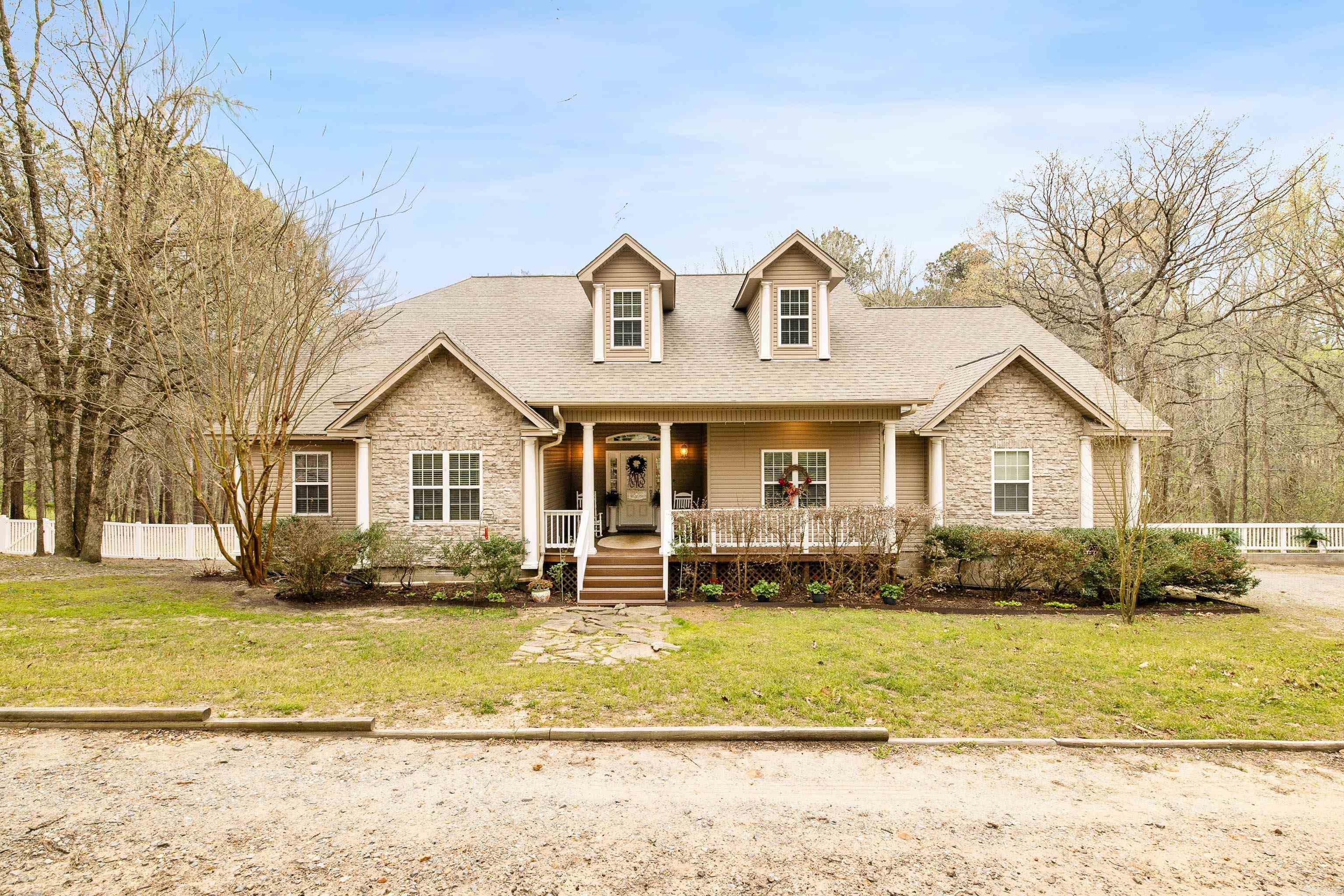 Looking for a home that gives you all the warm, cozy feelings with a peaceful setting that just makes sense? This charming home in the East End community has been so well cared for and was built with so much love. Nestled on just under 2 partially wooded acres, the setting feels private, quiet, and tucked away—and with a roof that’s only 3 years old. The floor plan is thoughtful and functional, perfect for families or anyone wanting a little extra space. Enjoy a large, inviting front porch made for rocking chairs and morning coffee. Inside, you’re welcomed by a grand living room with a beautiful stone fireplace. The kitchen features warm wood cabinetry, a breakfast bar, and a cozy breakfast nook, with a formal dining room just off to the side. The primary suite offers patio access, a soaking tub, separate shower, and walk-in closet. Two guest bedrooms and a full bath sit on one side, with an additional bedroom and private bath off the kitchen—perfect for guests. Unwind on the screened-in porch overlooking your peaceful backyard. A truly special place to call home.