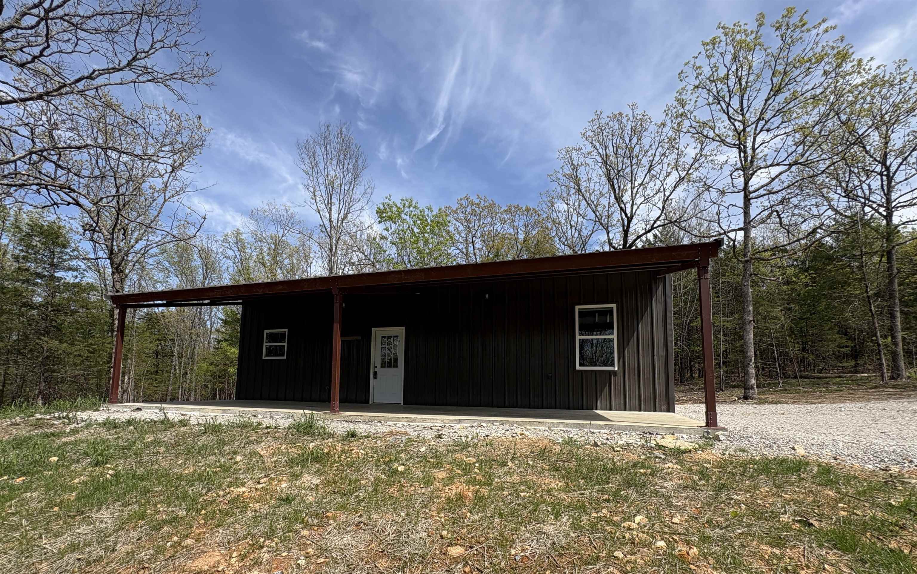 This beautiful 17.5-acre property (two tracts) offers incredible versatility. The 30'x40' red iron shop, built in 2025, is heated/cooled with a mini split and currently features 2 bedrooms, living area, full bath, and kitchen. It’s framed for a 12'x10' garage door, making it easy to convert back to a shop. The property includes 200 amp service for the shop plus an additional 200 amp setup for a future home. The septic system supports a 3–4 bedroom, 3 bath home—ideal for building while living on-site. Enjoy country views from the 30'x12' carport/porch and watch abundant wildlife. Pasture includes a water line for a future barn. The perfect homestead opportunity! This property is also listed with shop and 8+ acres separately MLS#26004607 and also 8+ acres separately MLS#26019085.