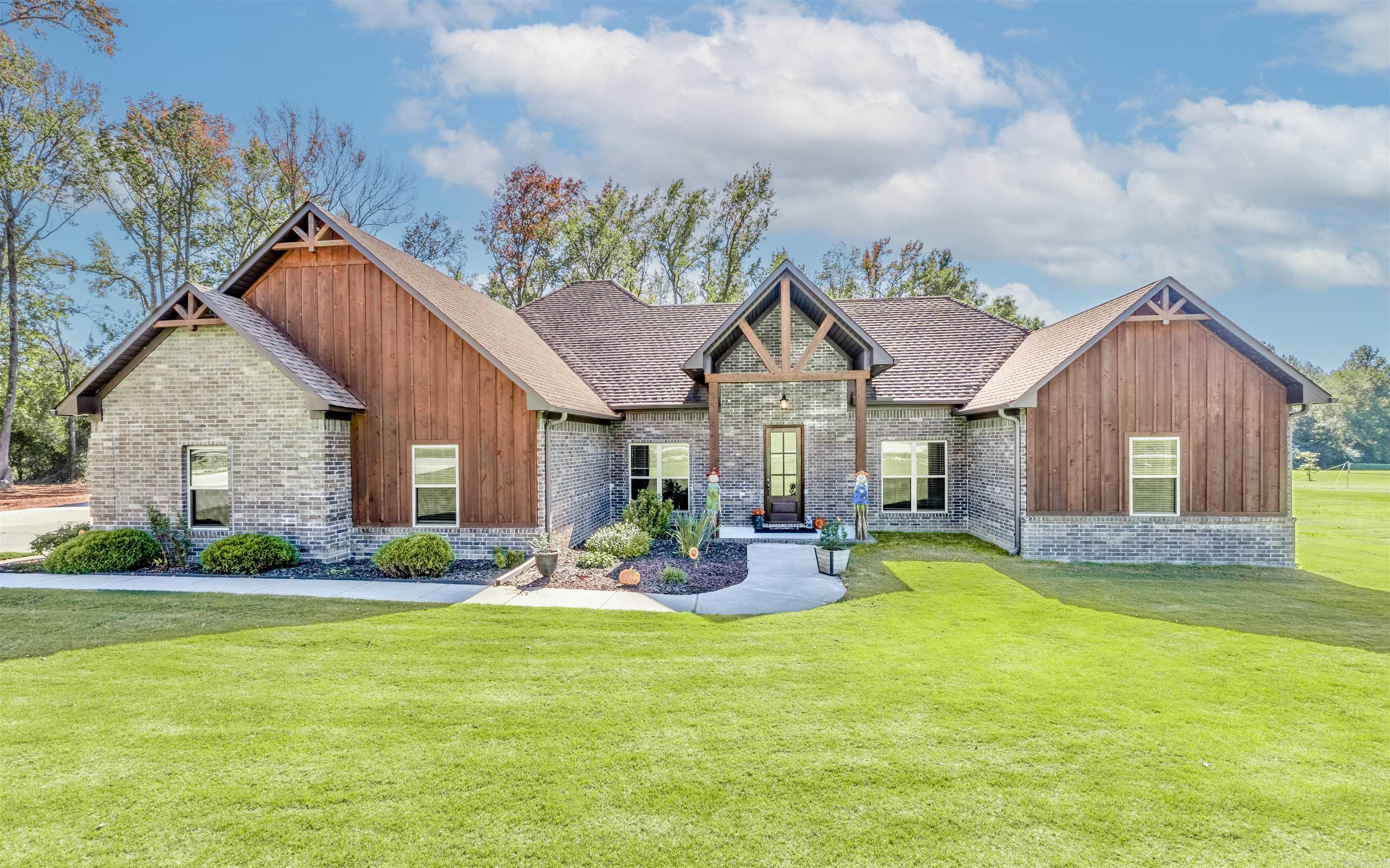 Check out this absolutely stunning 4 bedroom 2.5 bath custom home on over 2 acres in highly sought after Greystone Subdivision!  As you walk in you're greeted with an open concept and a custom kitchen flowing into the living area, with a  wood burning fireplace as center of attention!  This well designed floor plan works great for any large family, featuring several custom finishes, board and batten wood siding and 10 foot ceilings throughout. Oversized 2 car garage and a fenced in back yard for your pets is always a plus. Looking for in-law quarters? There is also a 40x40 red iron shop that has an 800 sq foot apartment built in, with an additional bedroom and full bath.  There were no expenses spared when designed and built for high efficiency low cost utilities. Upstairs features A separate office that's heated and cooled as a bonus! This building also has a high bay garage door that will keep that RV or boat secure and a solid concrete safe room added for your peace of mind as well.  If you are looking for that special place with plenty of yard to enjoy, book your showing today and make this Home!
