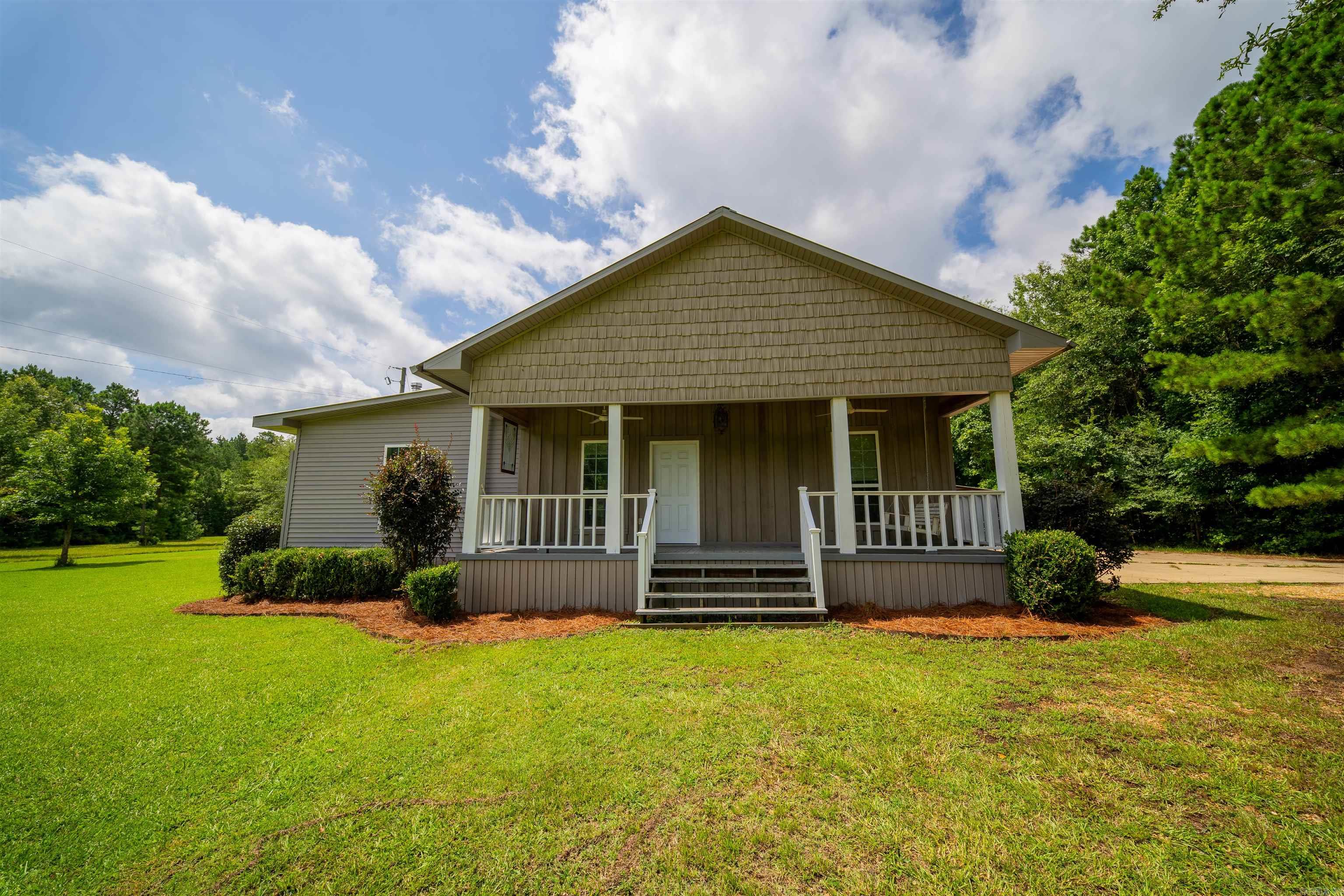 Welcome to the peaceful country lifestyle you've been dreaming of. Nestled on 6.3 acres, this modern farmhouse offers the perfect blend of timeless charm and everyday comfort all while being just a short drive from town. From the inviting front porch, to the spacious back deck, this property was designed to be enjoyed inside and out! Covered carports, and a small shop for storage, you have plenty of space for outdoor activities!