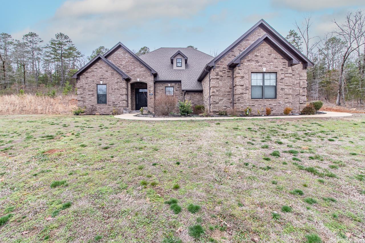 Enjoy the outdoor kitchen and the peacefulness of the land that goes way beyond the fence and up over the hill!   There is tall ceilings, great floor plan, lots of storage, good size garage, extra parking pad and a great neighborhood.  Wow love the space and all the storage.  Close to I 40, Conway, & Little Rock. Yes it is Conway Schools.  Only the bonus room is upstairs.  Bonus room can be made much bigger according to the seller with little change required.  All the other rooms are one level down stairs.  Extra land to the left is for sale next to this home if you want.   Great location where new homes are built around the area.  Enjoy the close convenience of the location with the wonderful country feel.