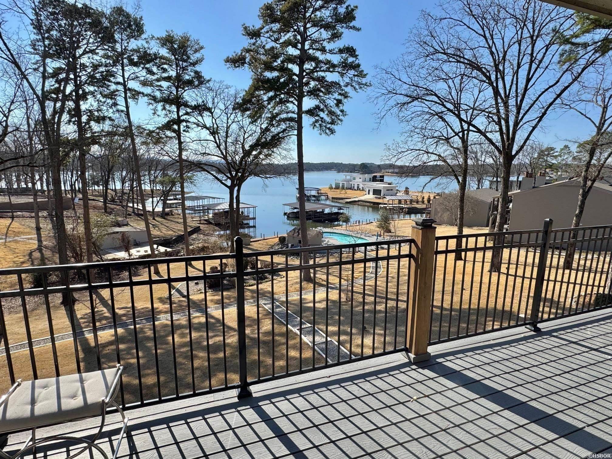 Enjoy relaxed lake living in this well-maintained 2-bedroom, 2-bath condo on Lake Hamilton. Recently updated with new paint and flooring. A private balcony off the living room offers peaceful water views and a great space to unwind. The open dining area is ideal for entertaining, while the primary suite features balcony access, a walk-in shower, and generous closet space. Covered parking is included with this condo. Community amenities include a swimming pool, boardwalk and nicely maintained common areas. The complex has recently completed exterior updates, including new roofs and decks. Perfect as a full-time residence or weekend getaway with easy access to boating, swimming and all that Hot Springs has to offer.