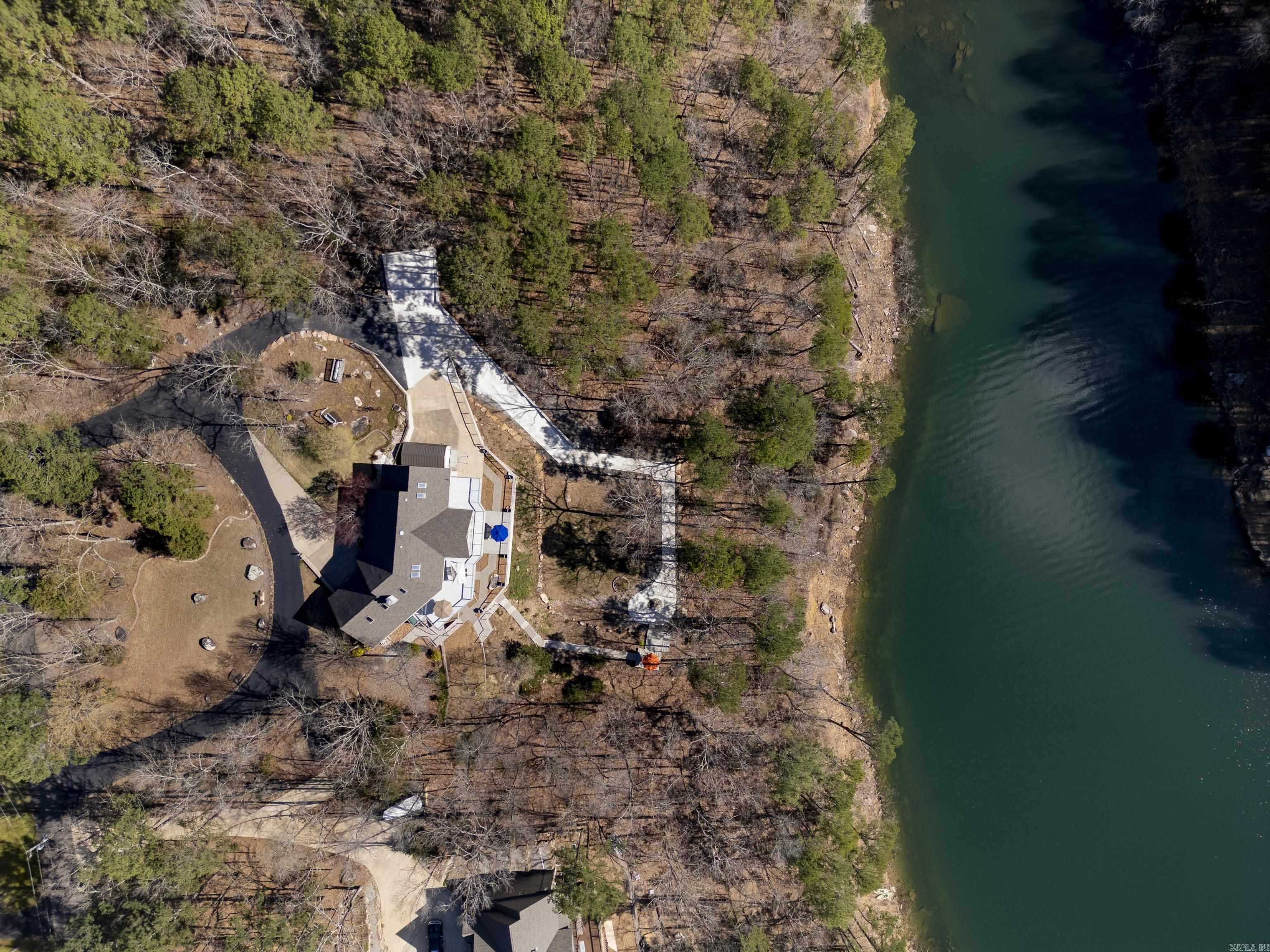 **LAKEFRONT on Greers Ferry Lake where every room has a view! This stunning 4656 sf home boasts breathtaking views and luxurious amenities, perfect for those seeking tranquility and comfort by the water. Nestled on the shores of Greers Ferry Lake, this spacious residence features: 5 bedrooms, 4.5 baths, & 2 living areas..  For all the cooks in the family, this kitchen is spacious and ideal for entertaining. Downstairs you will find an additional kitchen, living area and dining. Other features include a separate laundry room, central vaccum, 2 car garage, circle drive, landscaping and so much more.  Step outside onto the spacious deck and soak in the beauty of Greers Ferry Lake. With panoramic views and plenty of space for outdoor dining and lounging, this deck is the perfect spot to unwind and enjoy the serenity of lakefront living.  Boat launch an picnic area for neighborhood enjoyment. Escape the hustle and bustle of everyday life and experience the ultimate lakefront lifestyle at this exquisite Greers Ferry Lake home. Don't miss your opportunity to make unforgettable memories in this idyllic retreat. Schedule your personal showing today!