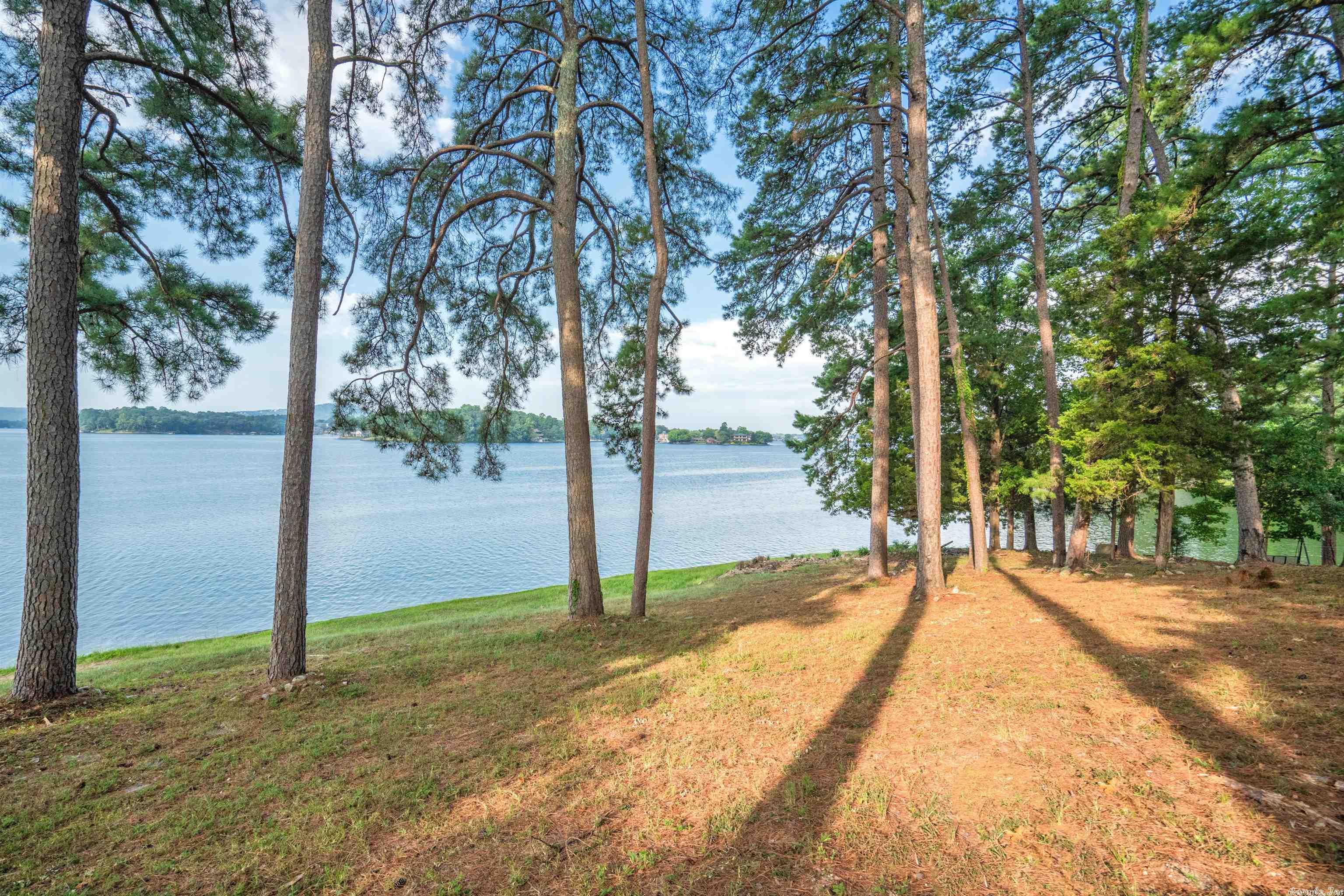 Build your dream home on this premier lake front property with approx. 200 feet of lake frontage!  Stunning, endless views of Lake Hamilton with year round water and just enough mature trees for privacy. The tranquil setting sits on one and one half lots and almost an acre.  Entergy has approved request for a single or double boat dock.  By boat or by land, all the conveniences are just minutes away. Call your architect and builder now!