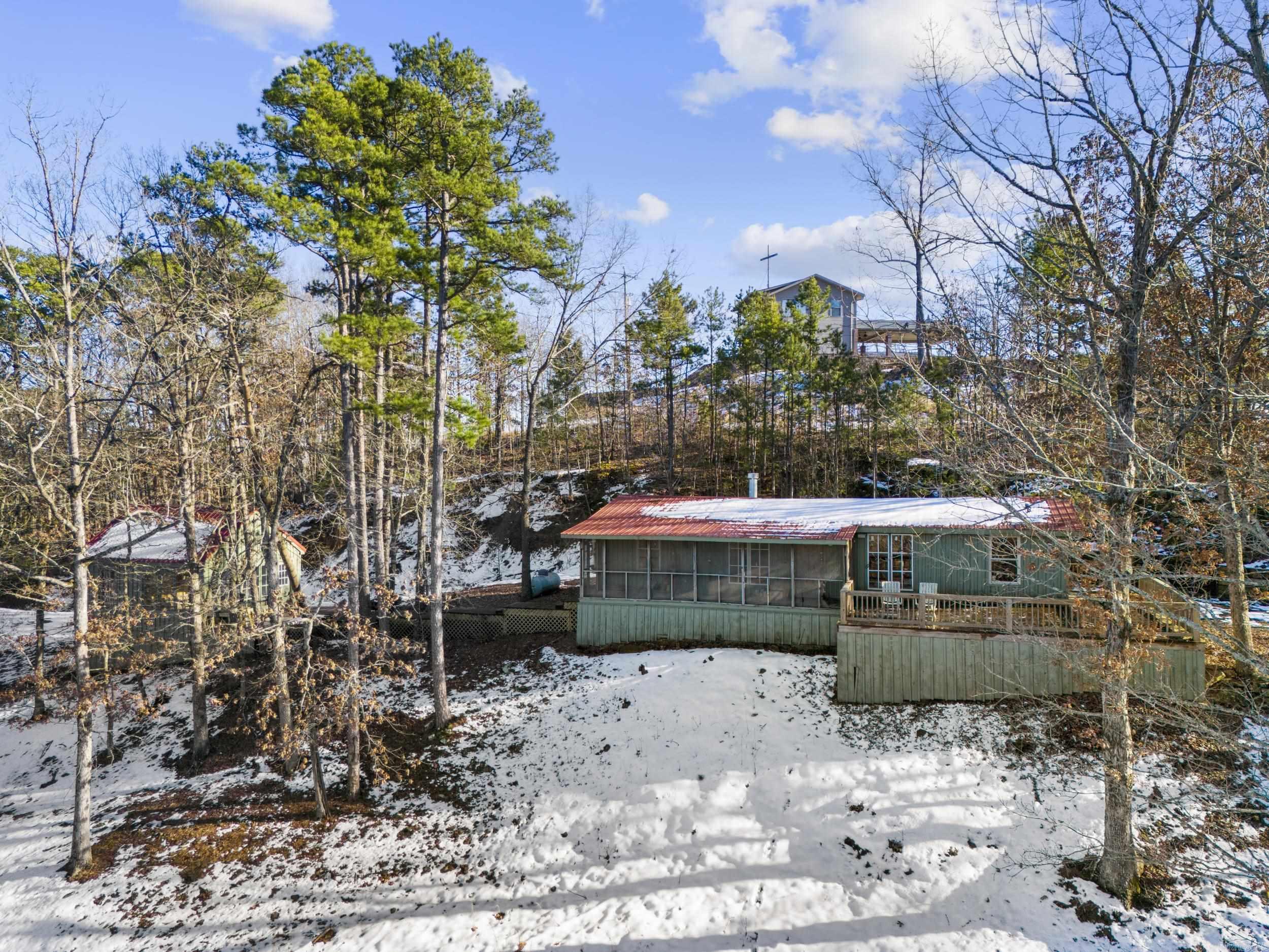 Discover your perfect lake getaway with this secluded 1.92+/- acre property in Higden, AR, offering breathtaking views of Greers Ferry Lake and the iconic Narrows Bridge. Situated just 1.6 miles from Lacey’s Narrows Marina and Narrows Park, this unique property has been a cherished, family-owned, lake-area retreat for over 25 years. The 960+/- sq. ft. main cabin is a renovation-in-progress, offering the opportunity to customize the kitchen and bathroom to your tastes. With renovations already started, the cabin is ready for your finishing touch to make it truly yours. Both the main cabin and bunkhouse have metal roofs. The 378+/- sq. ft. bunkhouse is fully completed, featuring a bunk room, cozy loft, full bathroom, and charming details perfect for guests or additional family members. Nestled on a quiet, private acreage yet conveniently close to local amenities, this property offers a rare combination of seclusion and accessibility. Make this hidden gem your family’s lakefront haven or a fantastic investment opportunity. Don’t miss out—schedule your viewing today!