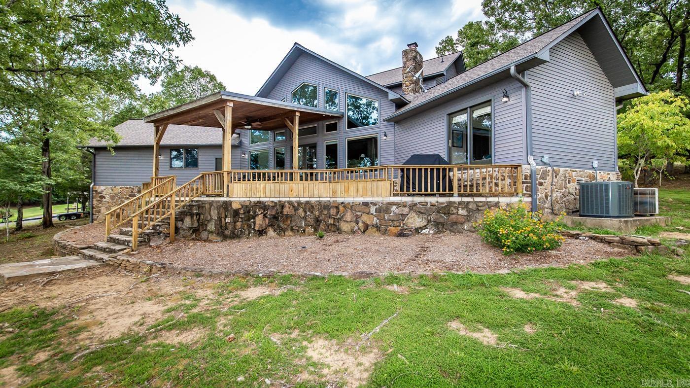 Discover the epitome of lakefront living with this extraordinary salt box-style home in Fairfield Bay, Arkansas. Situated on  2 lakefront lots, this property offers an idyllic retreat that combines breathtaking water views, a boat slip w/lift is available in the dock just behind house for $50,000. This property offers an abundance of amenities. Prepare to indulge in a lifestyle of relaxation, recreation, & unforgettable memories in this remarkable residence. As you enter this charming home, you'll immediately be drawn to the stunning lake vistas that flood the space with natural light. The great room features a wall of windows, allowing for panoramic views of the serene lake & creating an inviting ambiance that seamlessly connects the indoor & outdoor living spaces. Step into the spacious kitchen, complete with a convenient island, a breakfast area, & a large laundry room. The main floor of the home also offers two bedrooms & two baths, providing ample space for family & guests. Upstairs, you'll find two generously sized bedrooms, offering privacy & comfort, along with a well-appointed jack-and-jill bath. Take advantage of the dream-like lake life all year round.