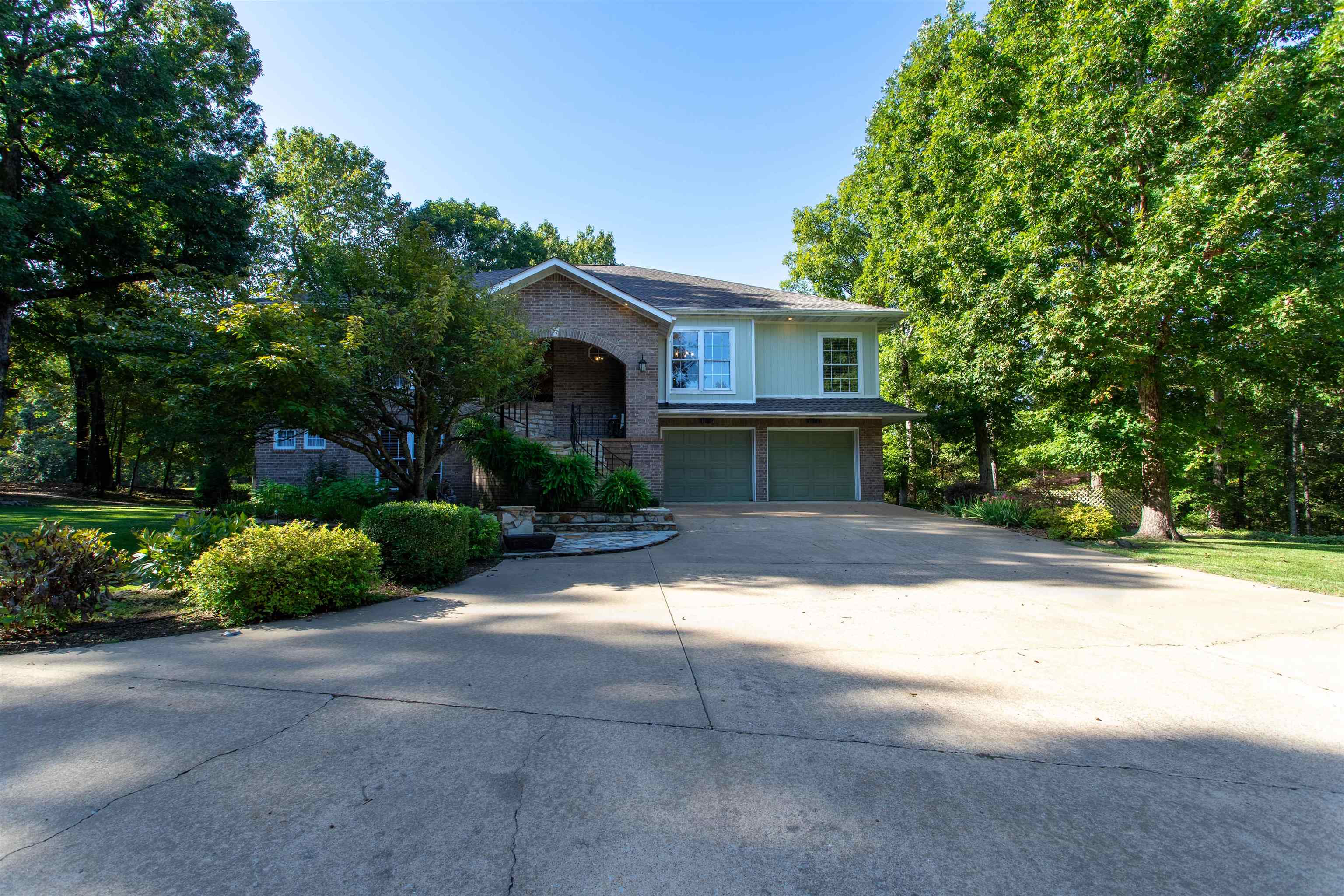 Golf course property, in the CV Spokane subdivision, offers access to the championship golf course and its amenities. Conveniently situated on a lane w/ privacy, yet near schools and town amenities. The grand entrance is outlined with ornamental landscaping, constructed with Ozark native stone welcoming you into the great room with floor to ceiling glass overlooking the Pristine greens, located at the 3rd green & 4th tee box. Beautiful maintained home, landscaped w/ meticulous attention to detail, including sprinkler system for easy care of  blooming perennials throughout the grounds.  The 5-bed, 3-bath, 2 car garage home features 4,530 sq ft, and offers open-concept design, and ceramic tile and hardwood flooring, w/ unique soft or bright lighting system.  The strategically placed windows offer natural lighting, with nature views of the golf course. The main floor’s electric fireplace establishes a cozy focal point for social gatherings. Perfect set up for 2 family living w/ kit & laundry both up & down. Shop 1146 sf heat & cool w/ 1/2 bath perfect for rec toys & hobbies.