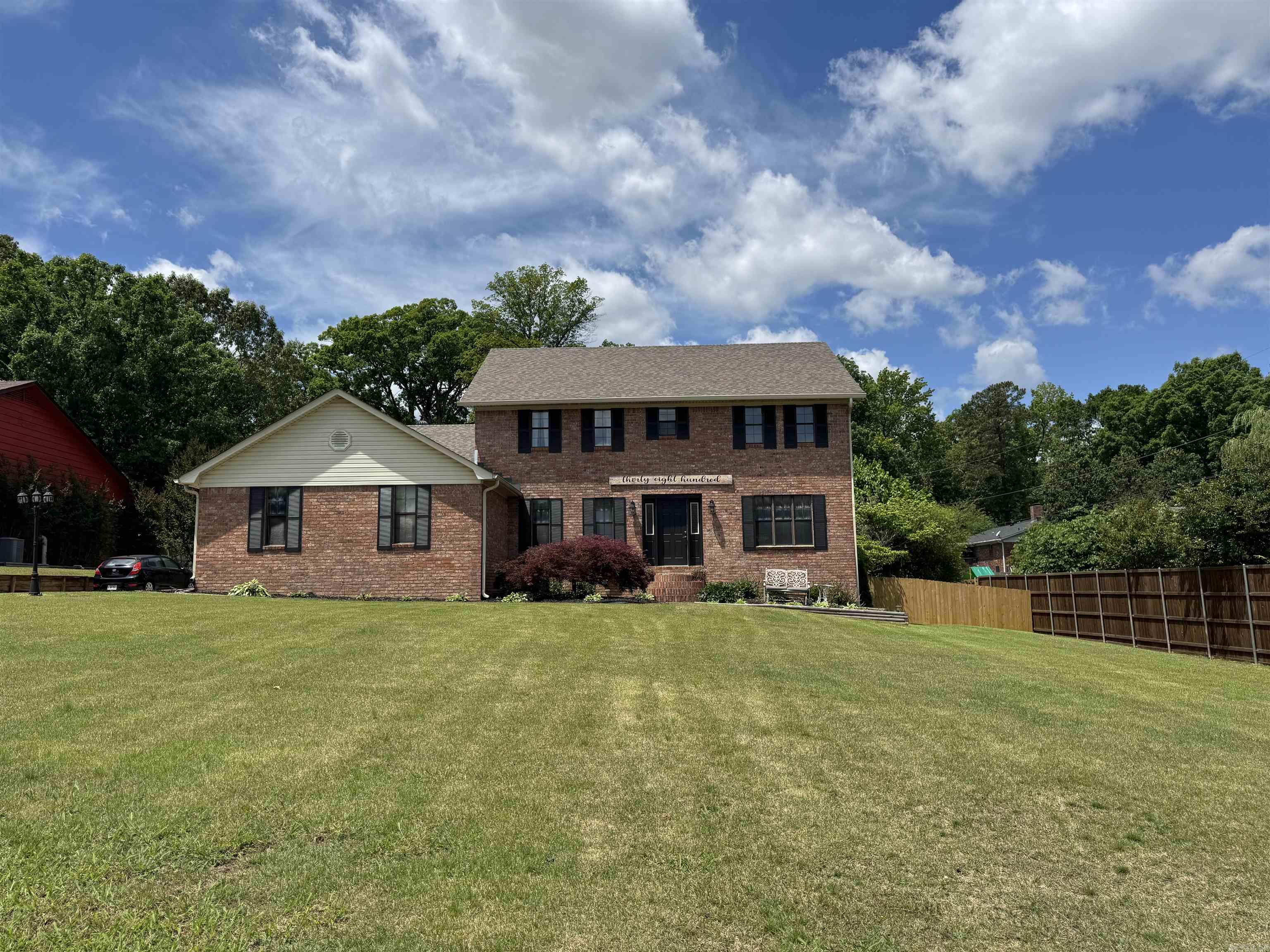 This all brick home offers over 3,400 square feet of comfortable living space with room for everyone! Featuring 5 bedrooms and 2.5 bathrooms, this thoughtfully designed home combines generous living areas with a functional layout perfect for everyday living and entertaining. The main level features an inviting open floor plan with a huge formal dining room, a breakfast room, and additional space for a kitchen table, giving you multiple options for hosting family gatherings and special occasions. The large den is the heart of the home, complete with a cozy wood-burning fireplace. The rustic sunroom or second living area adds even more flexible space for a sitting room, playroom, office, or media room. Conveniently located on the first floor, the guest bedroom provides privacy and flexibility for visitors or a home office setup. Upstairs, you’ll find four additional oversized bedrooms and two full bathrooms, offering plenty of space for family and guests. The enormous primary suite is a true retreat with room for all your large furniture. The basement has a kitchenette layout with a sink which will make entertaining or doing hobbies a snap.  Don't miss the back yard, it is amazing.