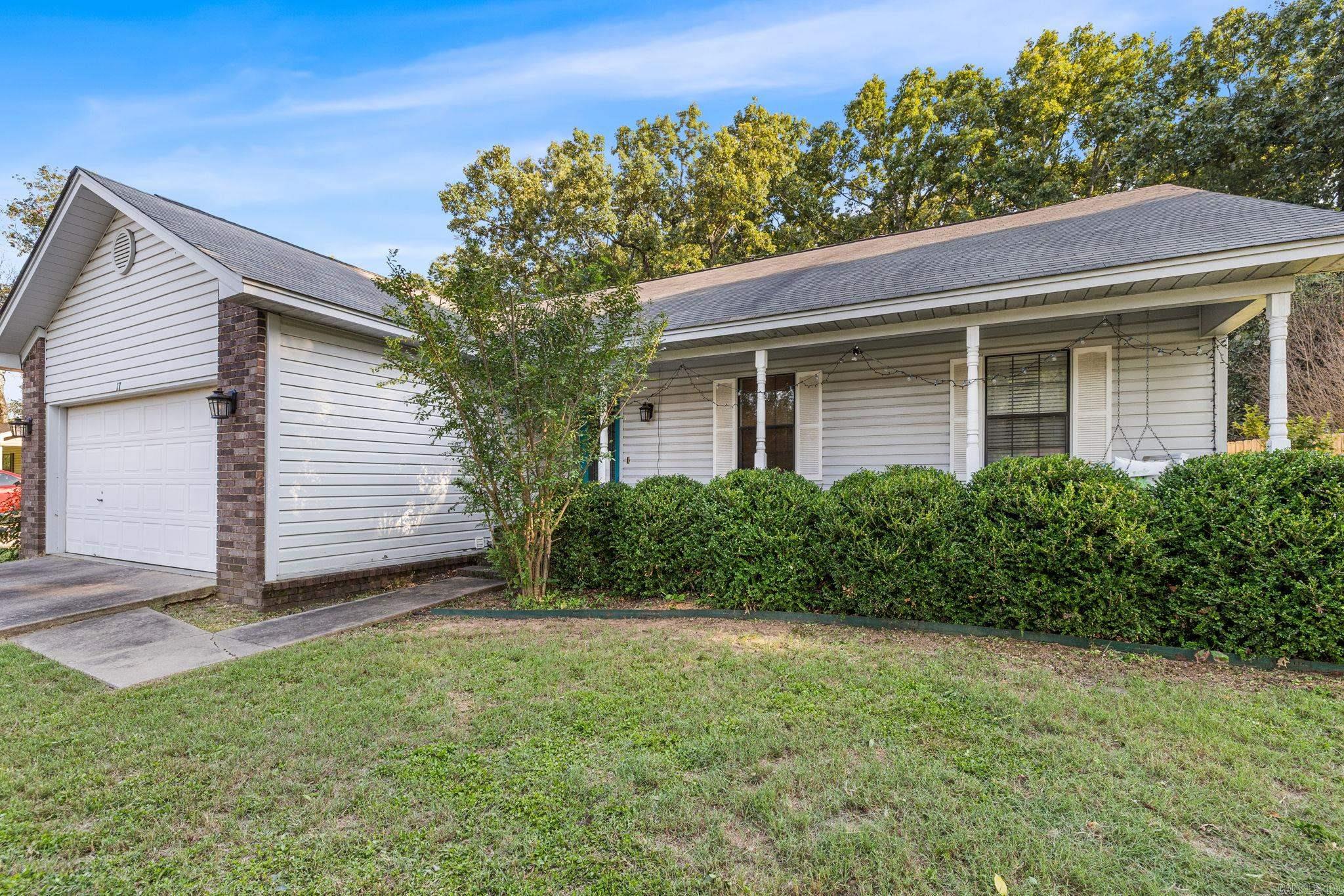 Charming 3-bedroom, 2-bathroom home offering 1,375 sq. ft. of comfortable living space! Buyers will love the inviting full-length front porch complete with a porch swing-perfect for relaxing mornings or evenings. The kitchen features bay windows that provide plenty of natural light and a great view of the backyard. The spacious backyard offers endless possibilities for entertaining, gardening, pets, or play. The great room has a vaulted ceiling with a gorgeous wood beam and two skylights.  Master bedroom has a vaulted ceiling with a wood beam as well!  The kitchen has plenty of cabinets and the refrigerator stays.  It is in a convenient location that has quick access to the highway, shops, restaurants & much more!  NOTE: Hot water tank will be replaced before closing.