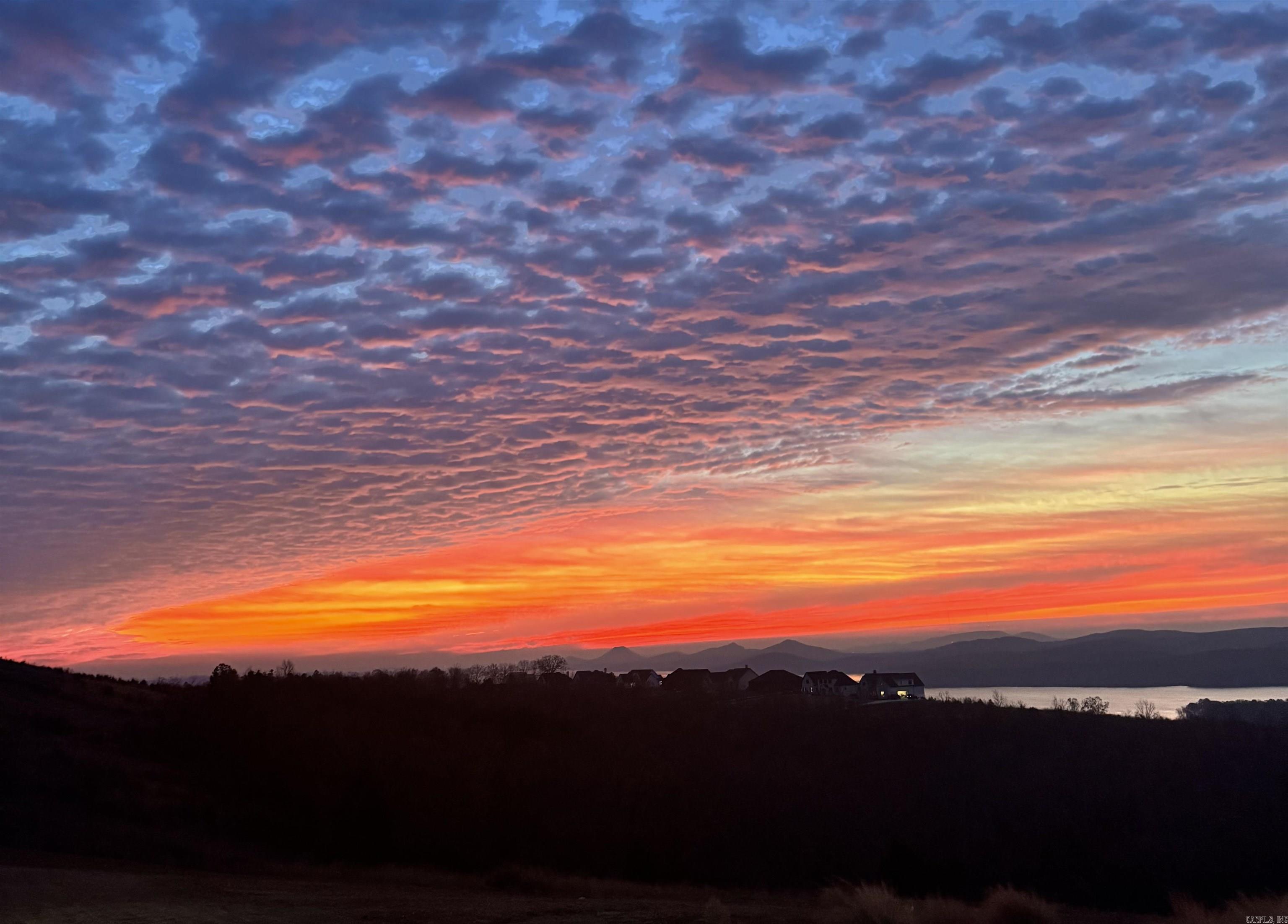 Spectacular, colorful skies at sunrise and sunset daily! Welcome to the gated Lakeview West community. Build your dream home on this stunning 1.2-acre ridgetop lot, offering the rare combination of a large, flat backyard and million-dollar views. Enjoy breathtaking vistas in every direction—overlooking sprawling Lake Maumelle, majestic Pinnacle Mountain, and the misty foothills of the Ouachita National Forest. The exclusive Alotian Golf Course and lake marina are just minutes away. A wonderful walking neighborhood! From the corner of the block, take in glimpses of Pinnacle Mountain and Lake Maumelle, then stroll through wooded trails along a meandering stream in the heart of this secluded enclave of beautiful estate homes. Lakeview West will soon add a 60-acre park featuring luxury amenities, including tennis courts, football and soccer areas, basketball courts, additional miles of walking trails, and a community bonfire area.  This lot is an exceptional find—offering incredible views along with the luxury of a spacious, flat backyard. Even more rare, it is the very last ridgetop lot available along Lakeview West Drive, making this a truly limited opportunity! Text me for details!