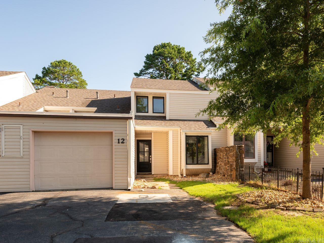Enjoy refined, low-maintenance living in this fully renovated condo overlooking the first tee of Maumelle Country Club. Perfect for golf enthusiasts and those seeking convenience, this home offers beautiful views, a community pool, clubhouse access, a private one-car garage, and outdoor storage.  The updated interior features modern finishes throughout, including new plumbing fixtures, quartz countertops, a redesigned primary bathroom with a new shower, refreshed half bath, fresh paint, premium lighting, luxury vinyl plank flooring, updated hardware, new door handles, and upgraded thermostats. The kitchen includes stainless steel appliances, an eat-in area, and a separate dining space ideal for entertaining.  The main-level primary suite provides convenience, while two upstairs bedrooms and a loft offer flexible space for guests, hobbies, or a home office. Additional improvements include a new AC compressor, new front door, and fresh sod.  Located in an HOA community with $360/month dues, residents enjoy pool and clubhouse amenities. The HOA replaced the roof approximately three years ago, adding peace of mind. This condo combines modern updates, comfort, and a prime location.