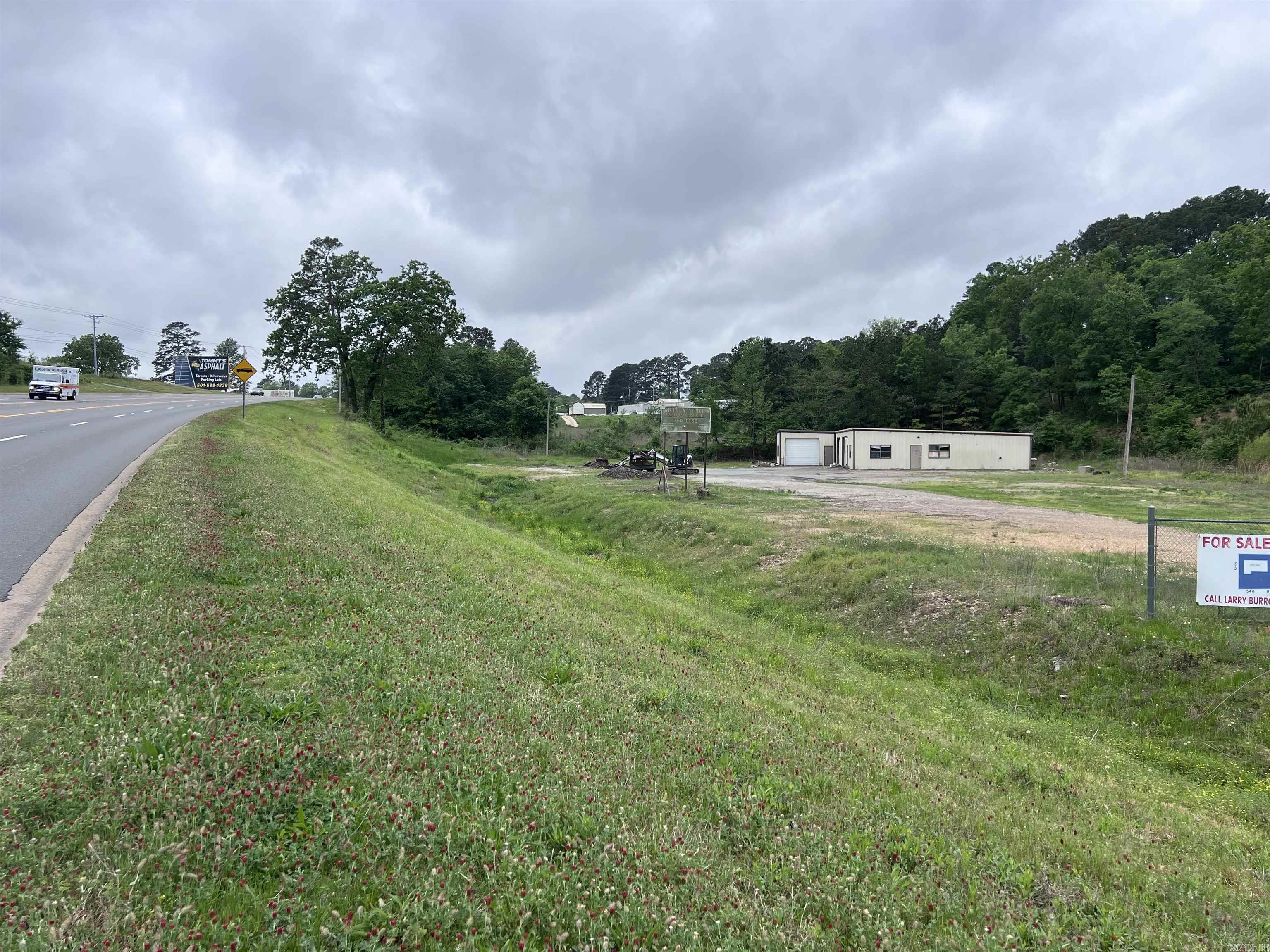 Prime commercial opportunity! This 5,100 sq ft warehouse sits on over an acre of level, usable land in a highly visible location with excellent accessibility. The property offers ample parking and flexible space ideal for retail, restaurant use, distribution, light industrial, or a variety of other business ventures.  With strong road frontage and high traffic exposure, this property provides the visibility and functionality businesses need to thrive. Whether you're expanding, relocating, or investing — this versatile space is ready for your vision.
