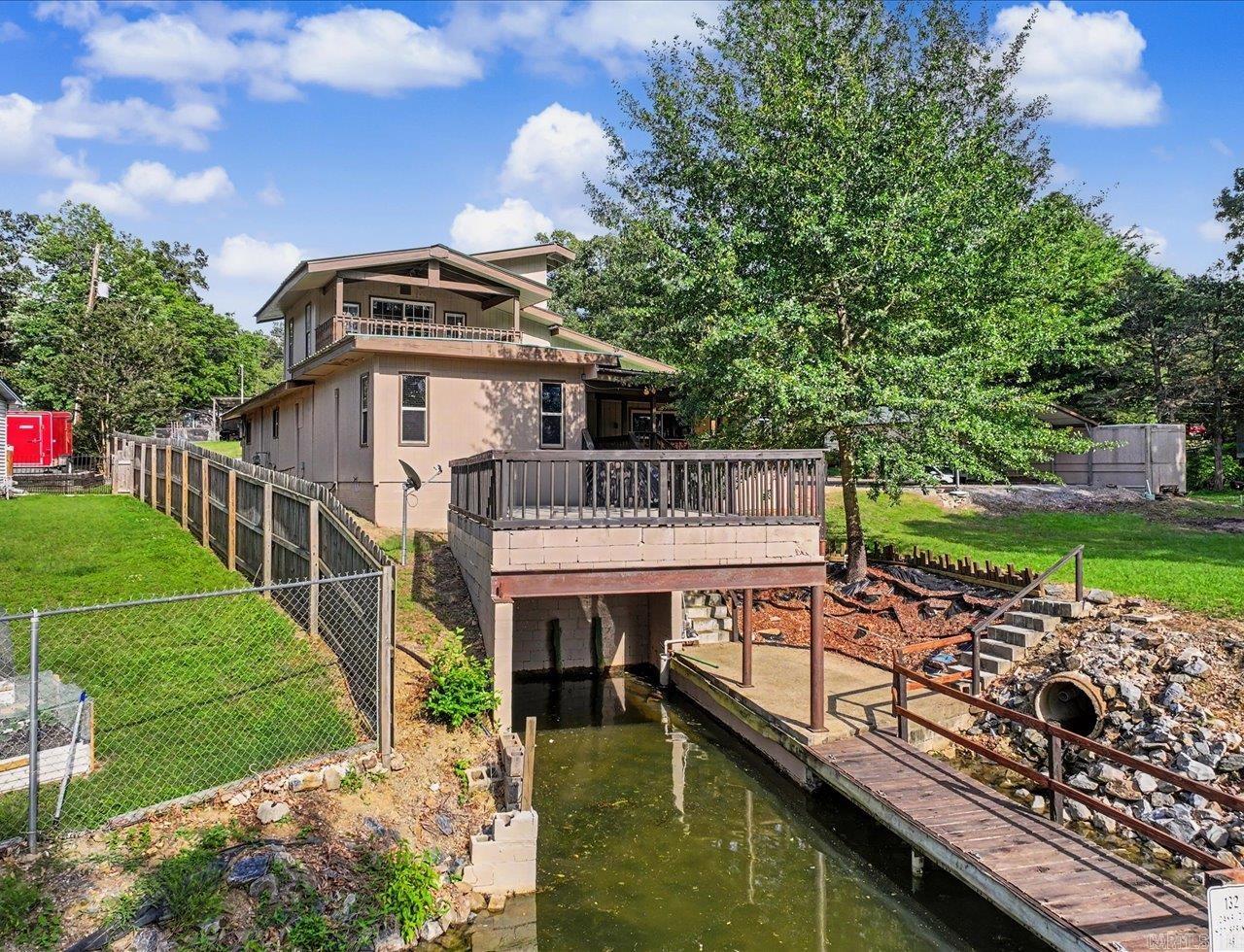 Lakefront Retreat with Private Boat Slip & Resort-Style Setting Lake Hamilton School District  Cute and well-maintained 3-bedroom, 2.5-bath lakefront home offering a peaceful resort-style setting and convenient access to the boat ramp located just behind the property. The home includes a private boat slip, making it ideal for enjoying lake living and water recreation.  Outdoor spaces feature a spacious back deck with both covered and uncovered areas, perfect for relaxing or entertaining while taking in the waterfront setting.  The primary suite includes an extra-large walk-in shower and a spacious walk-in closet, creating a comfortable private retreat. Additional updates include an HVAC mini-split system installed in 2023 for added efficiency and comfort.  All appliances convey, and most furnishings may convey with an acceptable offer, providing added convenience for a primary residence, vacation home, or investment opportunity.  A great opportunity to enjoy relaxed lakefront living in a quiet and scenic setting.