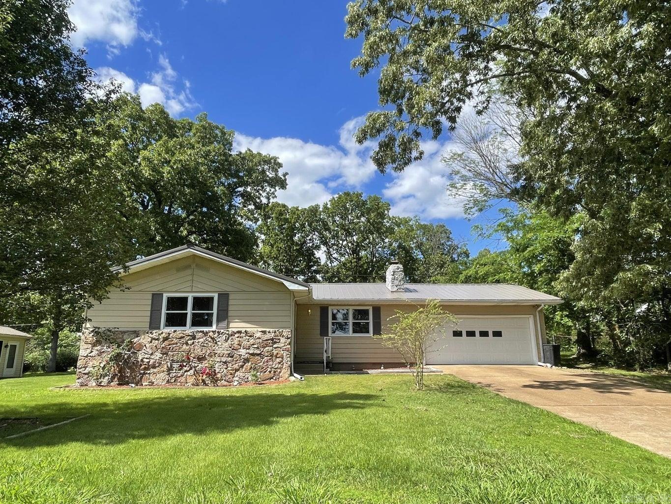Refreshed, move-in-ready 3-bedroom 2-bath 1260 sq ft home with a 2-car garage. Home features open floor plan, fireplace, separate laundry room/storage, metal roof, and a 456 sq ft private back deck. Great location, walking distance to Crown Lake and public fishing pier. Minutes to local amenities. Located on a quiet street ending in a cul-de-sac. Surrounded by a variety of wildlife and exotic birds. What we love: Very comfortable home. Enjoy sitting out on the back deck early morning listening to and watching the birds. Friendly, great neighbors. A forested park-like view out the dining room sliding doors and kitchen window. Convenient location.