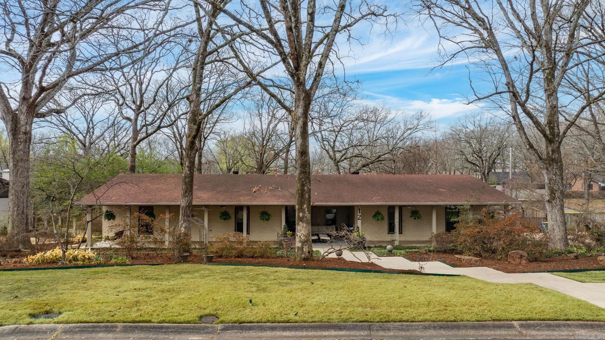 Welcome to 12 Edenwood Lane in North Little Rock — a home with history, charm, and exceptional functionality. Originally featured in the 1960s Parade of Homes, this property showcases thoughtful design and timeless character. This 4 bedroom, 2.5 bath home offers spacious living areas, updated bathrooms, and an updated kitchen ready for everyday living and entertaining. The primary suite features two walk-in closets and heated floors.  Abundant storage can be found throughout the home, including a large walk-in pantry.  Relax on the inviting front porch, unwind on the covered back porch, or enjoy the sunroom with hot tub overlooking the backyard. A 2-car garage provides additional storage and convenience.  With its unique history and generous storage, this home offers a rare one level floorplan on a culdesac in a charming North Little Rock neighborhood.