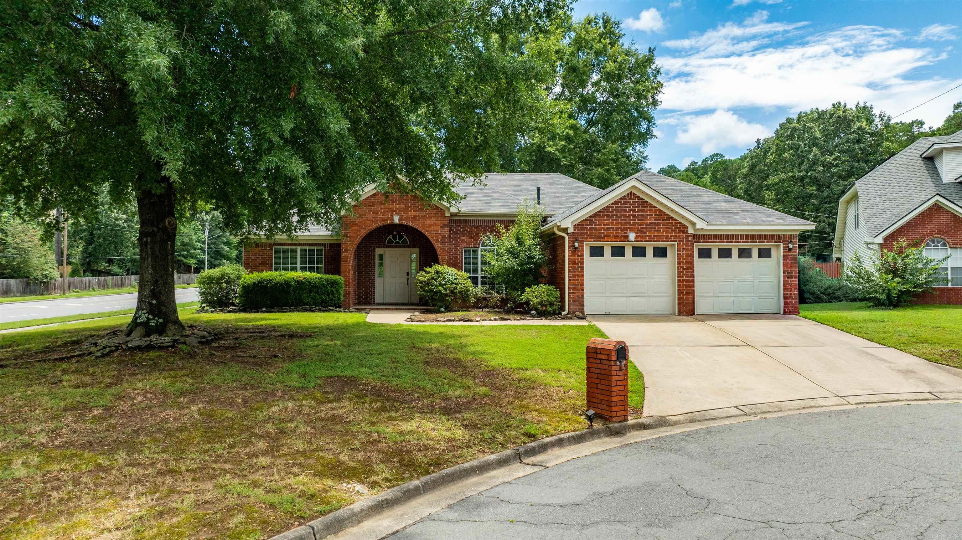 Welcome to this charming, turn-key one-story home in highly desirable West Little Rock, located just minutes from Don Roberts Elementary School. Situated on a spacious, level corner lot, this move-in-ready residence offers unparalleled convenience to premier shopping, dining, and major commuting routes. Inside, a functional split floor plan features two distinct living areas joined by a cozy, double-sided fireplace. Natural light floods the space through abundant windows, highlighting a fresh, warm white palette and durable luxury vinyl flooring. The bright kitchen boasts stainless steel appliances—including a stove, dishwasher, and microwave updated in 2019—plus a charming eat-in breakfast area. Elegant architectural details elevate the home, from the formal dining room's high ceilings to the sophisticated tray ceilings in both the living room and primary suite.The outdoor space features a fully fenced backyard with a large patio perfect for entertaining. For ultimate peace of mind, the home includes a dedicated garage storm shelter and a complete roof replacement from 2019. Schedule your tour today!