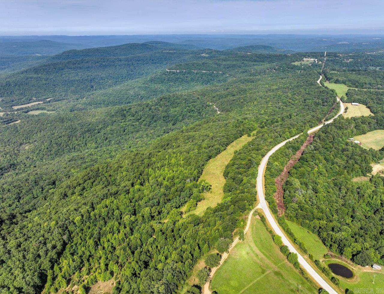 This 167.56-acre property in Deer, Arkansas, offers a rare opportunity to own a piece of the Ozark National Forest. Comprised of three adjoining tracts, the land features stunning waterfalls, dramatic cliffs, scenic overlooks, and unique rock formations, making it a paradise for nature lovers. With rolling terrain, picturesque vistas, and direct access to the National Forest, this property is ideal for conservation, recreation, or creating a private retreat. Whether you’re looking to preserve wildlife, enjoy outdoor adventures, or establish a secluded getaway, this land offers endless possibilities in the heart of the Ozarks.  Utilities available on site.