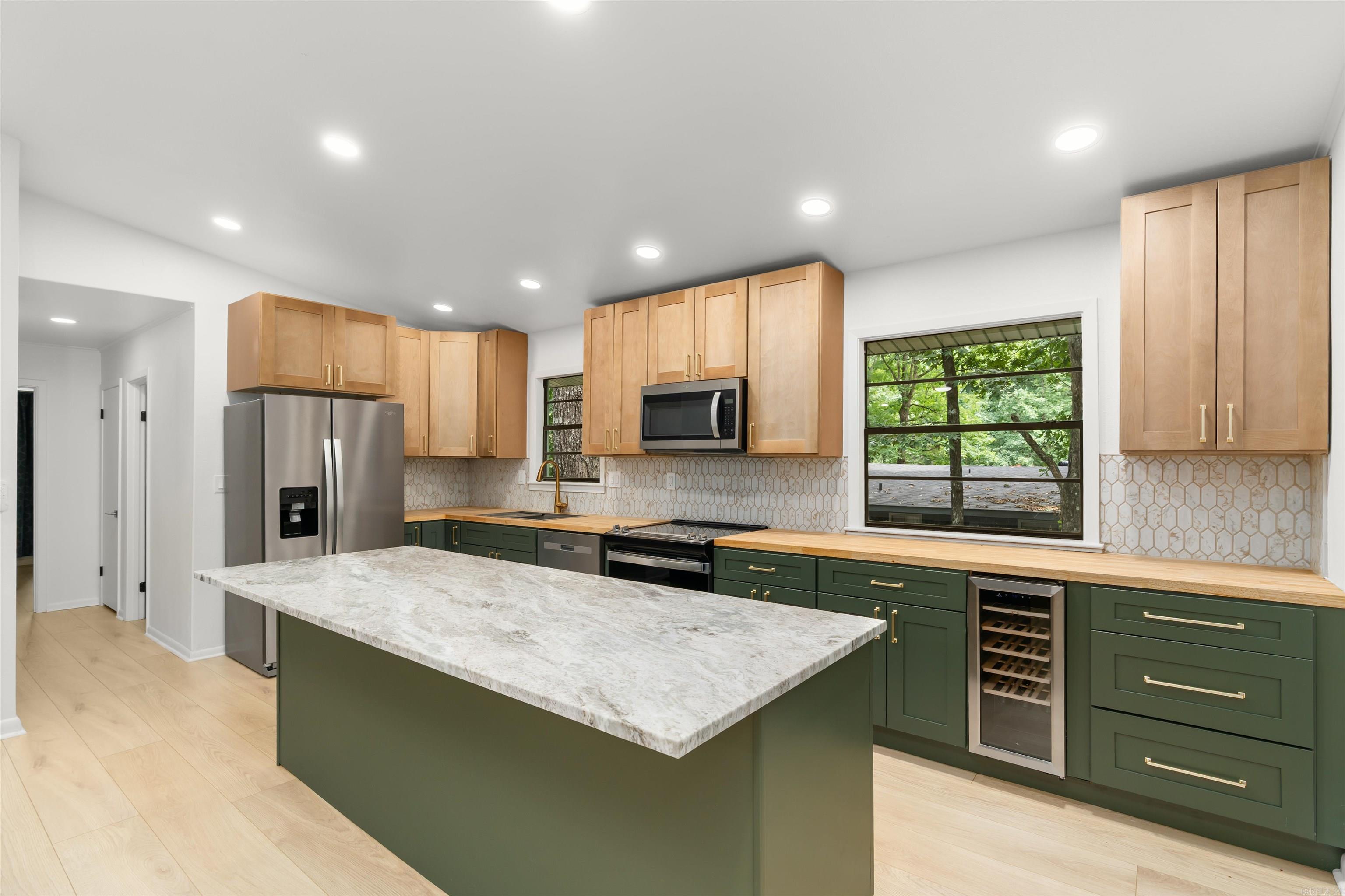BACK ON THE MARKET & BETTER THAN EVER! Avoid the stress of remodeling—this stunning, fully reimagined 2BR/2BA contemporary gem is 100% turn-key and ready for you. Tucked away on a quiet cul-de-sac, the property backs up directly to a protected greenbelt, guaranteeing your backyard privacy forever.  Reimagined top-to-bottom by licensed contractors, this home offers total peace of mind with a newer roof, newer HVAC, and completely updated electrical and plumbing (both walls and crawlspace). The chef’s kitchen is an absolute showstopper, boasting custom soft-close cabinetry, butcher block counters, a built-in 24-bottle wine fridge, and a massive 98x37 central island topped with premium quartz. High-end Whirlpool appliances and luxury LVP flooring flow seamlessly throughout. Unwind in the light-filled Arkansas Room or step outside to enjoy the world-class Hot Springs Village resort lifestyle—featuring 9 championship golf courses, 11 pristine lakes, and 30+ miles of hiking trails. High-end design meets mountain serenity. Schedule your tour today!