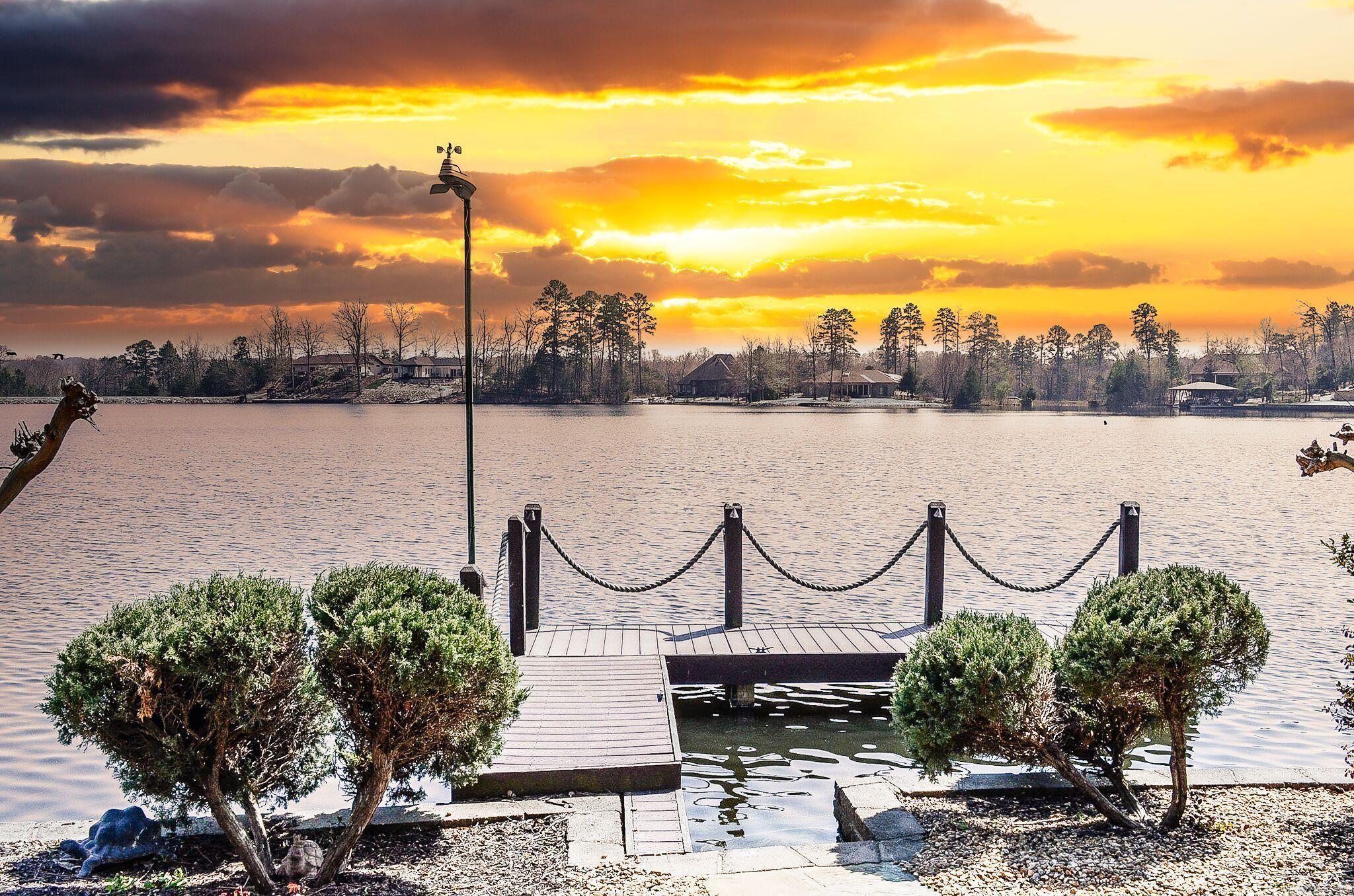 Lakefront luxury on Lake Sophia! This Renaissance-built home showcases classic French European architecture with 4 bedrooms and 4.5 baths, each bedroom featuring a private en-suite bath for added comfort and privacy. The open-concept central kitchen is ideal for entertaining and is complemented by a spacious Butler’s Pantry for additional prep and storage. Interior highlights include a dedicated media room, a built-in office, and a FEMA-approved safe room. Step outside to enjoy covered patios, decks and a brand new flagstone patio, outdoor fireplace, and a peaceful water feature—all designed for year-round outdoor living. The property offers 174 feet of seawall with a private dock, making it perfect for lakefront enjoyment, boating, and relaxing water views. There is audio and video surveillance on the exterior of the property. Interior photos coming April 1st. Call now for your private VIP showing. See Associated Docs for full features list.