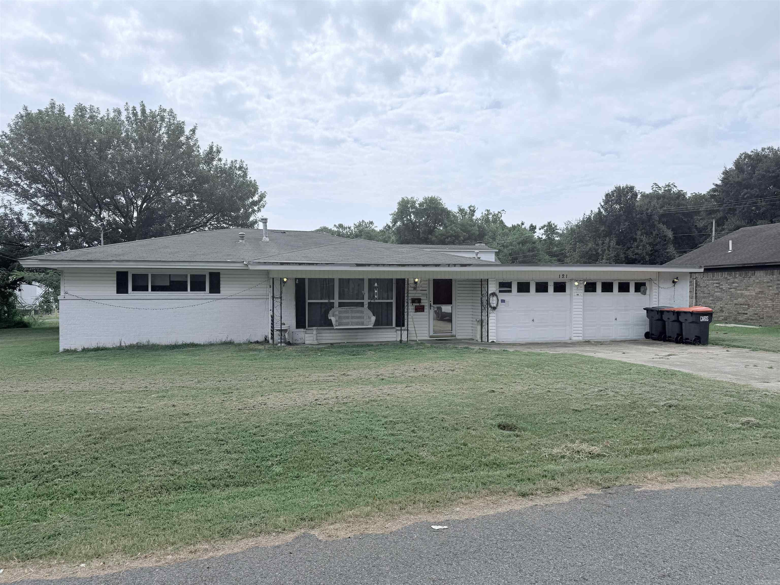 Packed with potential! This 3-bedroom, 1.5-bath brick home offers 1,244 sq. ft. of living space on over two lots with an attached 2-car garage. Major updates include new windows (2020) and a new HVAC system (2023). Inside you’ll find laminate flooring, central heat and air, and a kitchen with abundant cabinet space. The refrigerator and washer convey. Enjoy the fully wood-fenced backyard, screened-in porch, and 8x10 storage shed. Conveniently located just minutes from schools, shopping, dining, and more. A great opportunity for buyers looking to build equity or investors seeking their next project. Sold AS IS, WHERE IS. AGENT SEE REMARKS