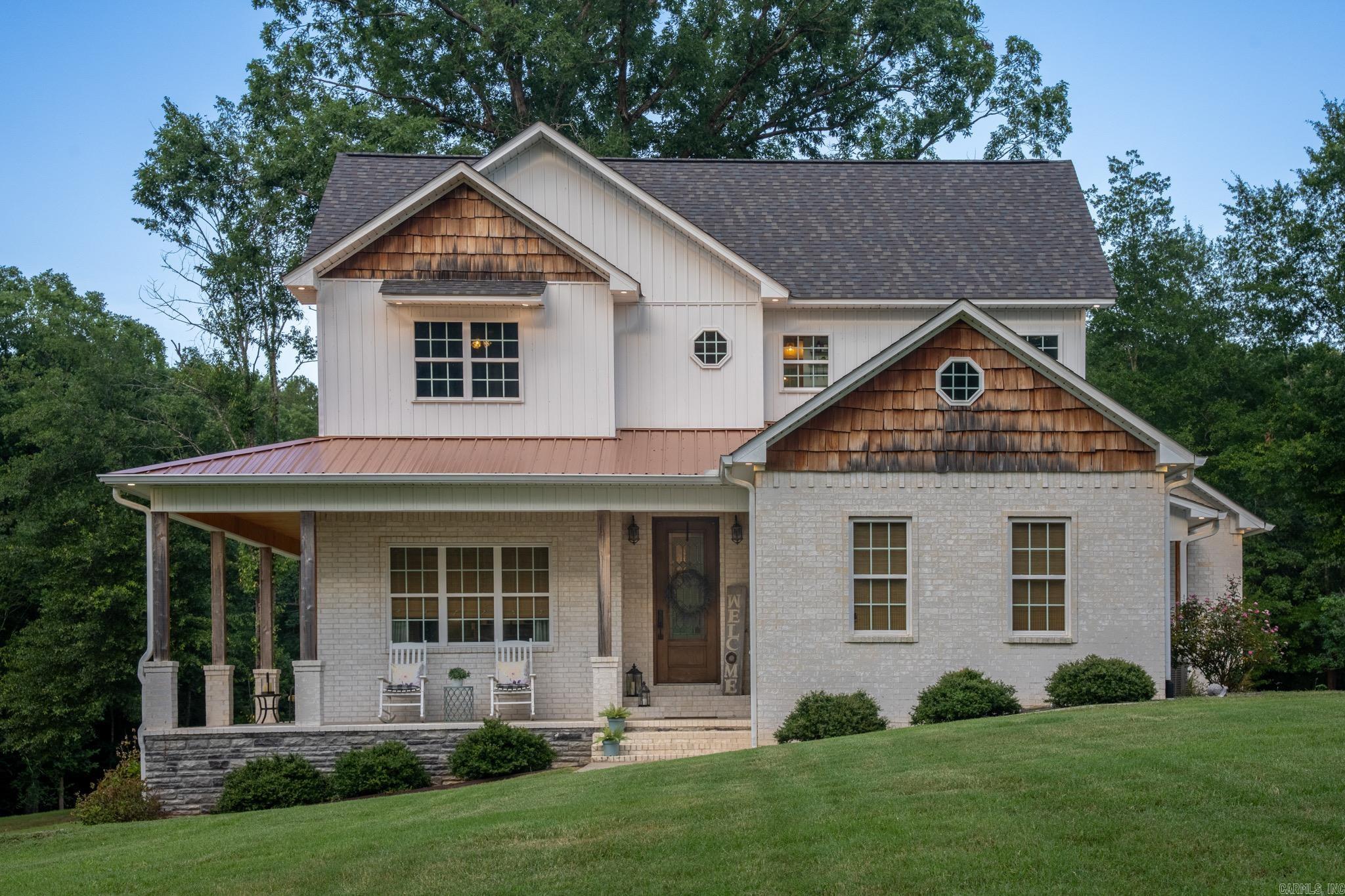 Custom-built and loaded with thoughtful upgrades, this stunning 5-bedroom, 3.5-bath home sits on a full acre and offers the perfect blend of comfort, functionality, and craftsmanship. Enjoy outdoor living year-round from the wraparound porch featuring an outdoor kitchen and fireplace.  The spacious primary suite is conveniently located on the main level and features a luxurious en-suite bath. The open-concept living area showcases a gas fireplace, gas range, oversized pantry, and abundant natural light. A half bath with direct garage access provides added convenience when enjoying the outdoor living spaces.  Upstairs, you’ll find four generously sized bedrooms, each with its own walk-in closet, along with bathrooms featuring dual vanities to accommodate family and guests.  Custom details set this home apart, including an under-stair office nook, pocket doors, hidden attic access, built-in drawer outlets in the primary bath for styling tools, and exterior holiday light outlets controlled by an interior switch.  The impressive 30’ x 40’ fully insulated shop is plumbed for a future bathroom, offering endless possibilities for a workshop, hobby space, home gym, or additional storage.