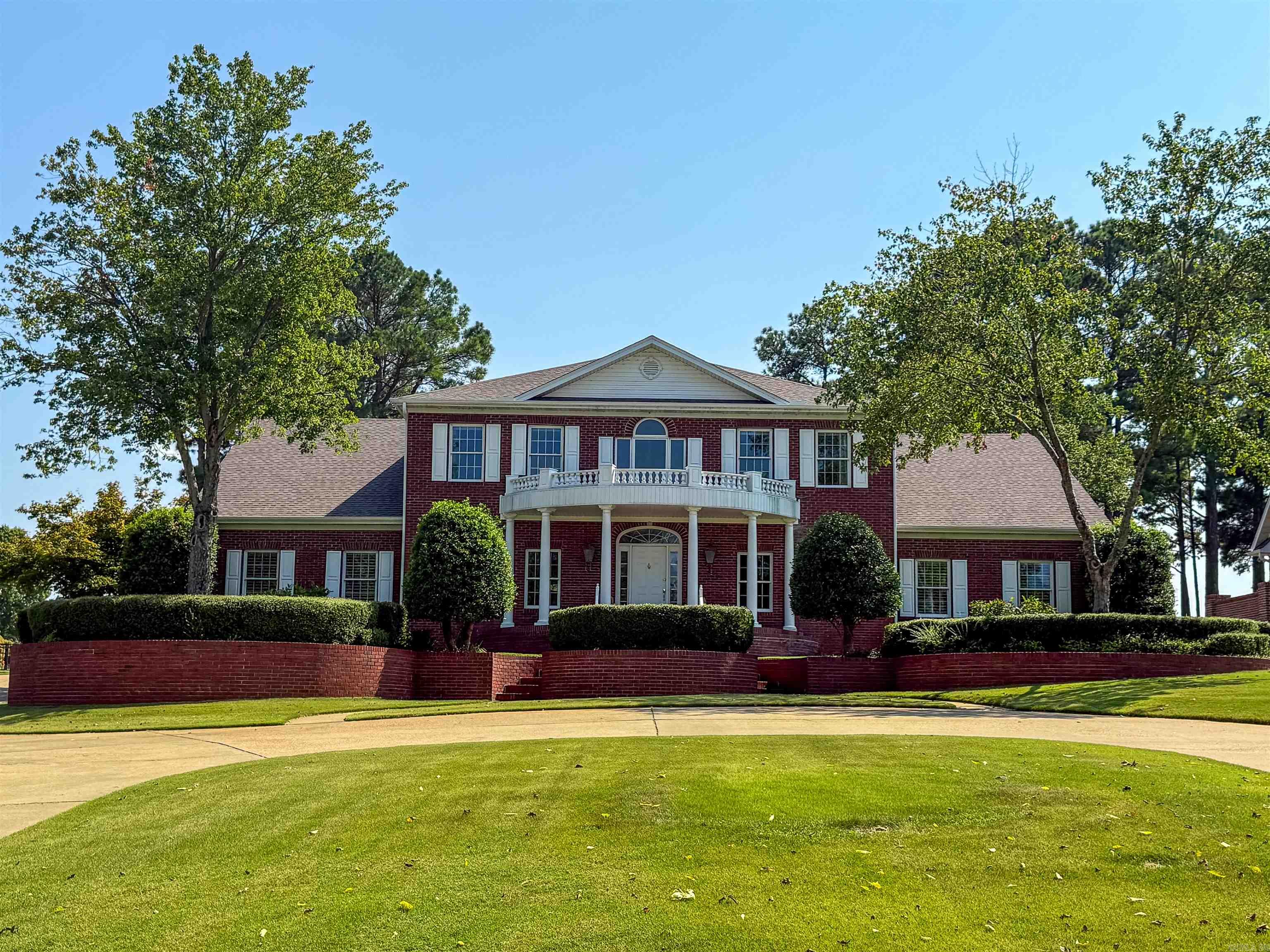 An elegant manor that you can call home. This beautiful 4 bedroom, 4 and a half bath home is nothing short of a masterpiece. A home that truly embodies a place fit for a king. The grand entryway is framed with a stunning wooden staircase and formal dining room. There are two living areas on the main floor one being a formal drawing room and the other a large living room. There is a two way fireplace between the living room and another informal gathering space leading out to the screened back patio. The patio has a woodburning fireplace, a bar area with granite top, a grilling area and a hot tub. The screens are retractable and are brand new! At the edge of the backyard you will have your private view of the gorgeous water feature which sits between you and the golf course. The kitchen has granite countertops and stainless appliances including a gas stove top and an informal breakfast area. There is also an ice maker and two dishwashers. Large pantry and wet bar between formal dining room and kitchen. The primary bedroom is very roomy and includes a luxurious spa-inspired ensuite with high end cabinetry and generous countertop space perfect for both functionality and style.