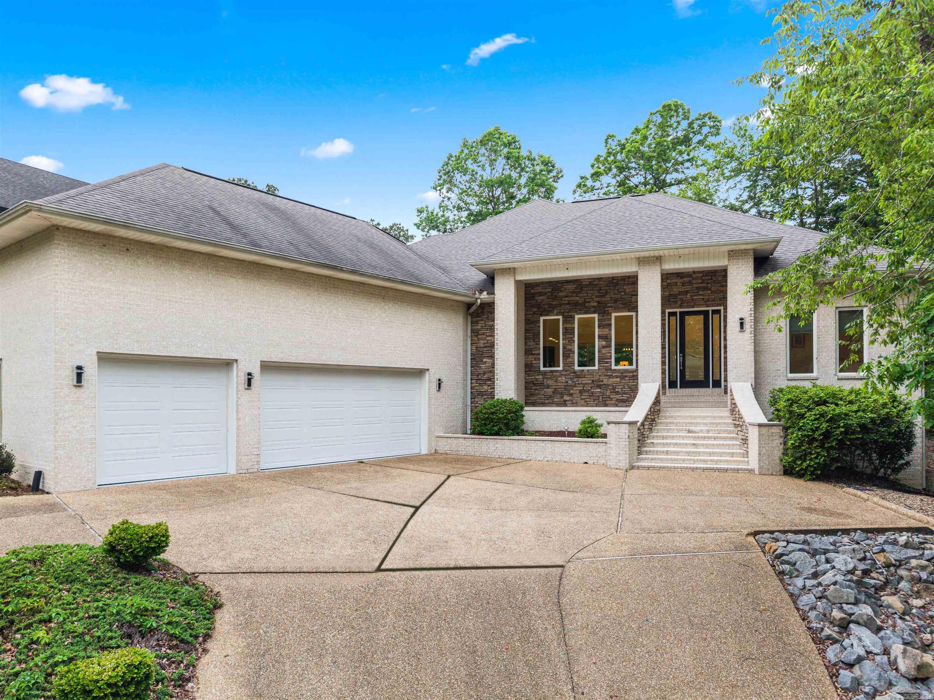 Elegantly designed Custom Home that rivals new construction! Highly desirable neighborhood on the 8th tee of Granada Golf Course and across the street from Lake Granada! The craftsman/contemporary blend of this home boasts SOARING CEILINGS, and an open concept, split bedrooms floorplan! The wall of windows to the rear of the home looks out onto the Covered Patio with Gas Fireplace and your own Putting Green! All the quality features you are looking for, Massive Ensuite with Glass Bowl Dual Vanity, Soaking Tub, Walk-in Shower and Organizer-filled Walk-in Closet! Chef's Island Kitchen with Smooth-top Range and loads of storage! Oversized Laundry Room + Pantry/Storage Room (currently serves as housekeeping closet for Airbnb supplies). Huge 3 Car Garage is currently set up as a Sport Court for activities - this is currently a successful Nightly Rental! Seller will credit buyer for a NEW ROOF at closing! 180sqft Storage Room/Shop Heated/Cooled under the house! Culdesac location and a Circular Driveway! 26,000 acre, gated, Hot Springs Village boasts 11 Lakes & 9 Golf Courses, 20+ Miles of Walking Trails, Fitness Center, 2 Pools, Pickleball, 2 Marinas - DON'T MISS THE VIRTUAL TOUR LINK!