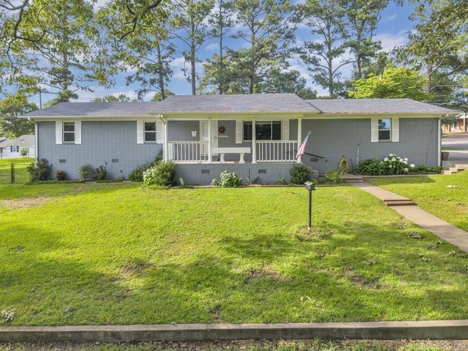 Welcome home to this well-maintained all-brick beauty situated on a spacious .72 acre corner lot! Large living room and big formal dining space is perfect for gatherings! Kitchen comes fully equipped with all appliances conveying. Separate laundry room where washer & dryer also stay. Laminate flooring runs throughout this home, providing a clean, modern look with no carpet to maintain. Step outside and enjoy the covered concrete patio overlooking the fenced side yard. Mature trees provide plenty of shade! Storage building conveys & 2-car portable carport conveys. There is a small workshop inside the garage. This property offers the perfect combination of comfort, functionality, and value.  Don't miss your opportunity to make this wonderful home yours!
