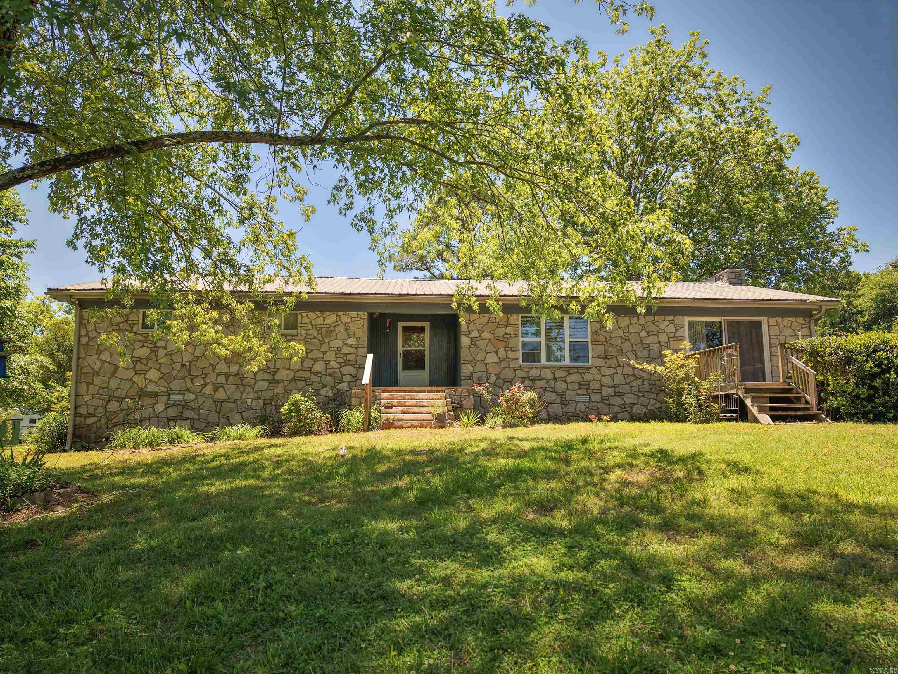 Nestled on 9.13 acres (±), this 2,292 sqft farmhouse offers space, privacy, and versatility, set back off the highway for peaceful country living! The property features a durable metal roof, fenced and cross-fenced pasture ideal for cattle or other livestock, and a small stock pond at the front corner of the land! Enjoy outdoor living with a front deck and an in-ground pool in the backyard, perfect for relaxing or entertaining. A 30x40 barn/shop with electricity adds excellent functionality, while updates throughout the home blend modern comfort with farmhouse charm. Inside, the home includes a large kitchen, a spacious living and dining area with sliding French doors, a cozy fireplace, and central heat and air for year-round comfort. An additional room can serve as a bedroom, office, study, or sitting room. The property also offers a 440 sq ft guest apartment beneath the 2-car attached carport, connected by a breezeway to the back entrance of the home—ideal for guests, extended family, or rental potential. Located just 7.3 miles to Pocahontas, 3.6 miles to Imboden, and 45 miles to Jonesboro.  **Lot line drawing is approximate and for reference only!**