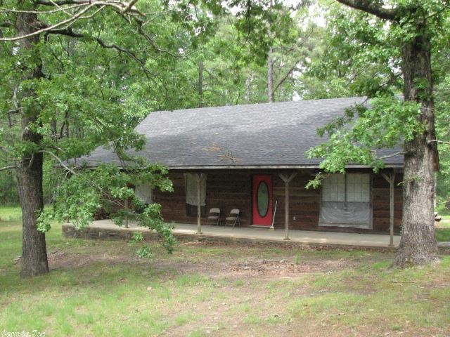 Bismarck or Malvern Schools - Remote, secluded, woodsy, with beautiful trees and a little creek out back, this 1380 sf cedar and stone home could be the one you've been looking for.  Needs a little work, but price allows for a few repairs.  7.5 acres of total privacy.  Roof is a year old.  Good well water - 200 ft deep. Shop building.