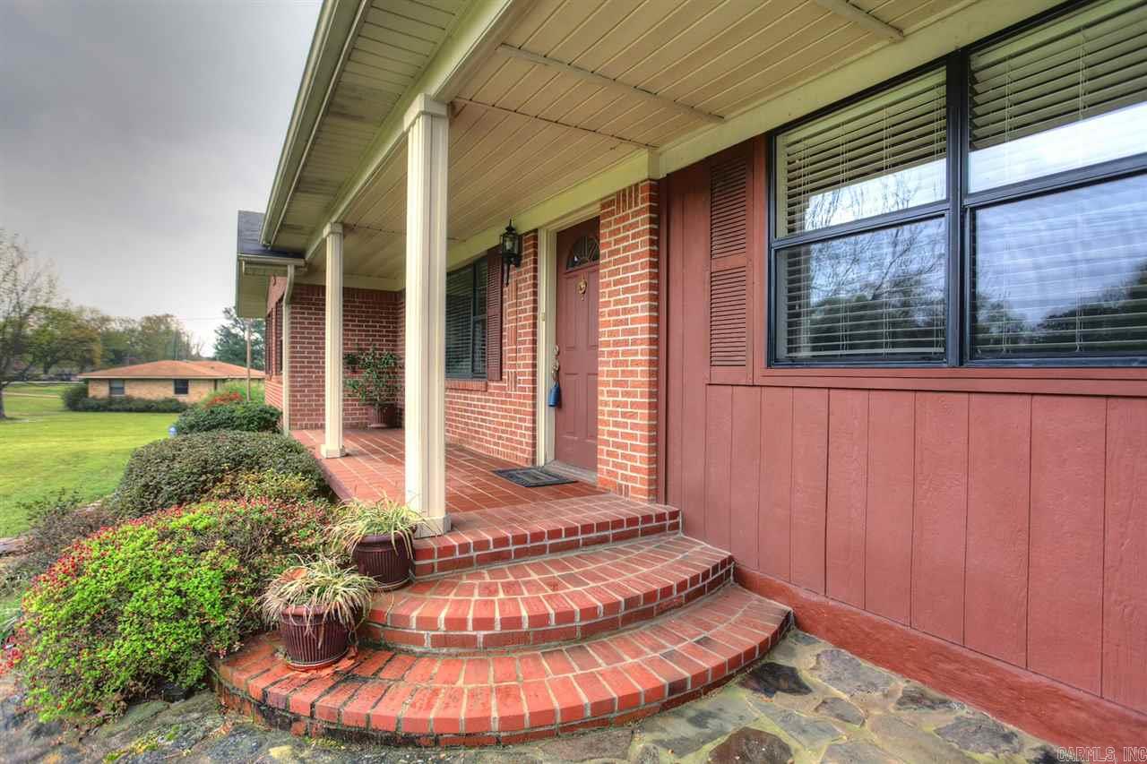 Wonderful 3 bedroom, 2 bath house, shop, large garage all on 2 acres.  This house has a large formal dining.  The kitchen overlooks the backyard.  Large laundry room.  There is a covered back porch with an outdoor kitchen. Tons of wonderful landscaping!  The shop has electricity, water, & wood burning stove for heat.  This house won't last long. A wonderful house with tons to offer!!!
