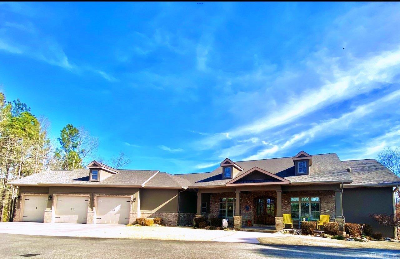 ONE OF THE BEST QUALITY BUILT LAKEFRONT (East Exp on Lakeside), ONE LEVEL, 3 CAR OVERSIZED INSULATED GARAGE with electric lift allowing more storage to floored attic. This elite custom construction by ELLISON Construction features so many upgraded features it would be impossible to list them all.  Top of the line on everything. Crown molding, beautiful wood floors, 3 Bedrooms, 2 1/2 Baths, Office, Great Room with beams, 10' Ceilings, Split Bedroom Plan, Formal Dining, Eat in Kitchen, Gas Range. Extra Large Pantry, granite counters, 2 Refrigerators and Washer/Dryer convey.  Heating system has 3 separate zones for convenience, pre-wired for portable generator. Mostly wood throughout, Carpet in guest bedrooms, heated tile in master bath, tile in guest baths and laundry rm. Beautiful seasonal lake views of open water, swim dock and boat ramp included. 2 Covered Decks, Lake fed sprinkler system and maintenance free professional landscaping. ROOF was replaced in 2023. Approximately 3137 Square Ft. h/c all on one level. Offering Price: $789,000.