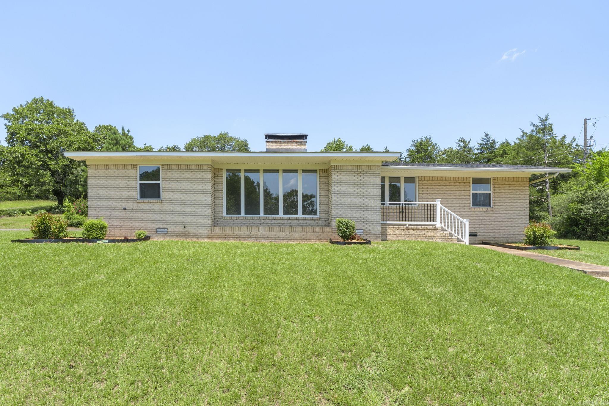 Enjoy the best of both worlds with this beautifully updated 4-bedroom, 3-bath ranch-style home on nearly 2 acres, offering a peaceful setting just minutes from shopping, dining, and schools. Move-in ready, this home features a bright living room filled with natural light from its many windows, plus a cozy family room with a fireplace. The functional layout includes a separate dining room and breakfast nook, while the spacious primary suite offers a private en-suite bath, three closets, and a dedicated makeup vanity. With modern updates, room to spread out, and a convenient location, this property is ready to welcome you home. No Seller Property Disclosure is available. Buyers are encouraged to verify home square footage and lot size through their own measurements. Some photos have bee virtually staged.