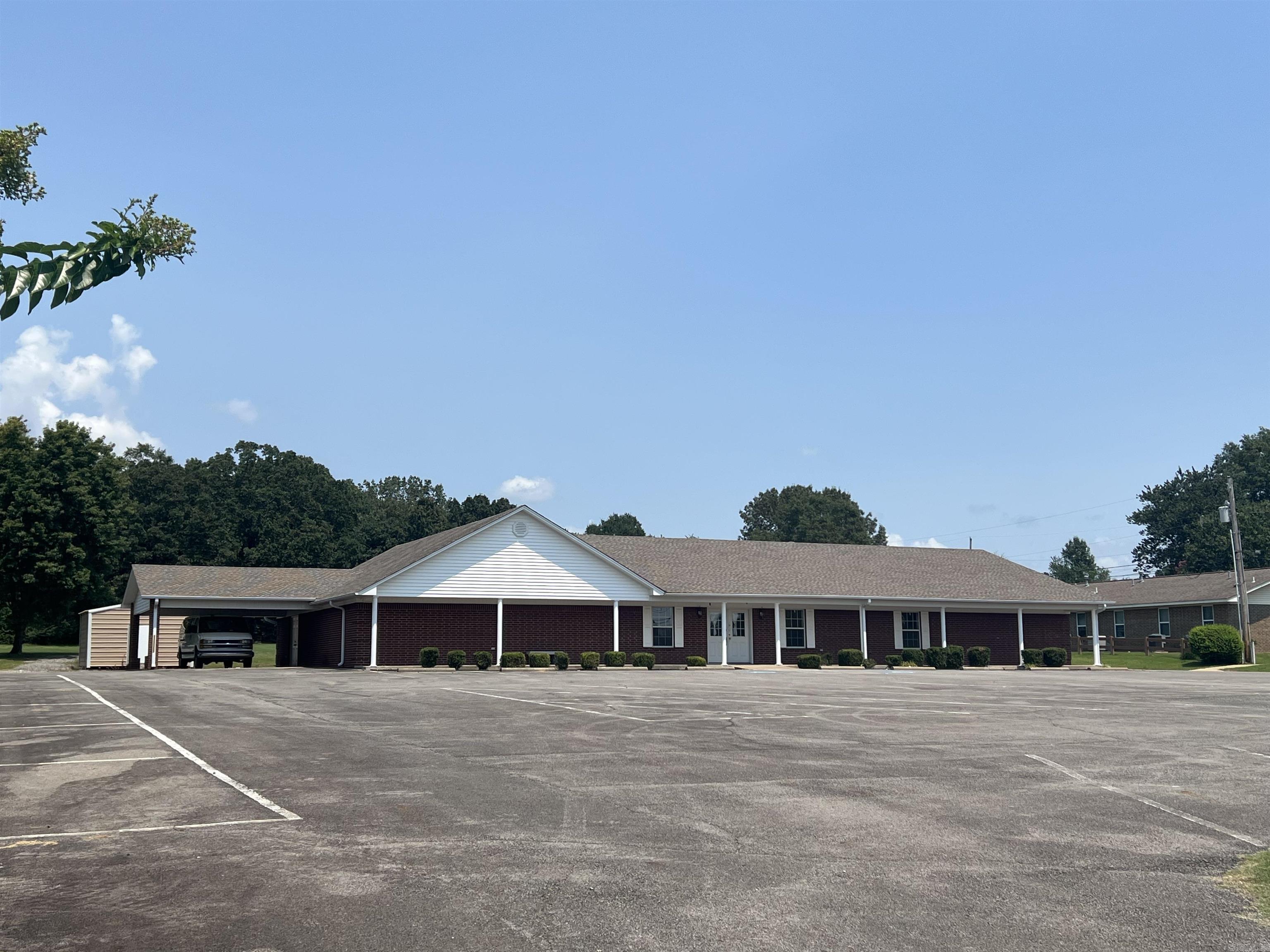 Great location! Most recently being used as a church with multiple rooms for offices or class rooms.  Also, has 2 half baths, a kitchen and additional storage space.  Large parking lot and with 2.65 +/- acres you have room to expand.