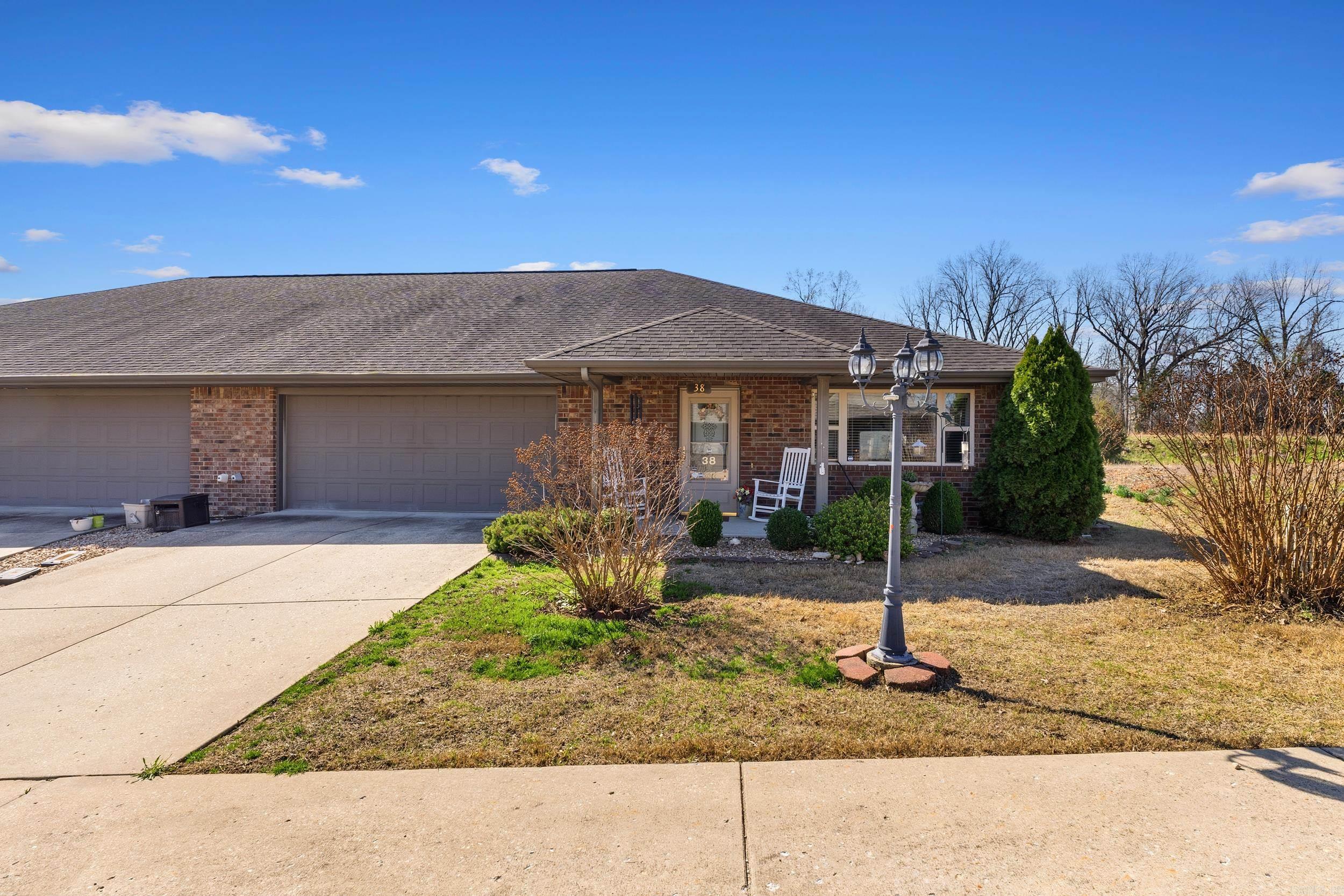 Enjoy easy living in this all-brick townhome located in the desirable Devonshire 55+ community in Lakeview, Arkansas, just minutes from Bull Shoals Lake, the White River, and Mountain Home in the heart of the Twin Lakes area. Built in 2007, this single-level home with no stairs offers 2 bedrooms and 2 full bathrooms with a split floor plan designed for comfort and privacy. The open-concept kitchen features abundant counter space, a generous breakfast bar, ample cabinetry, and a double pantry—perfect for everyday living and entertaining. The spacious primary suite includes a raised ceiling, walk-in shower, and large walk-in closet. Additional highlights include a 2-car attached garage, dedicated laundry room with sink and a convenient back door leading to the private deck. Residents enjoy community RV and boat parking, ideal for those who love spending time on nearby Bull Shoals Lake or fishing the world-famous White River. Located close to the city walking trail, local bank, and post office, this home offers comfortable, low-maintenance living in one of the most scenic areas of North Central Arkansas.