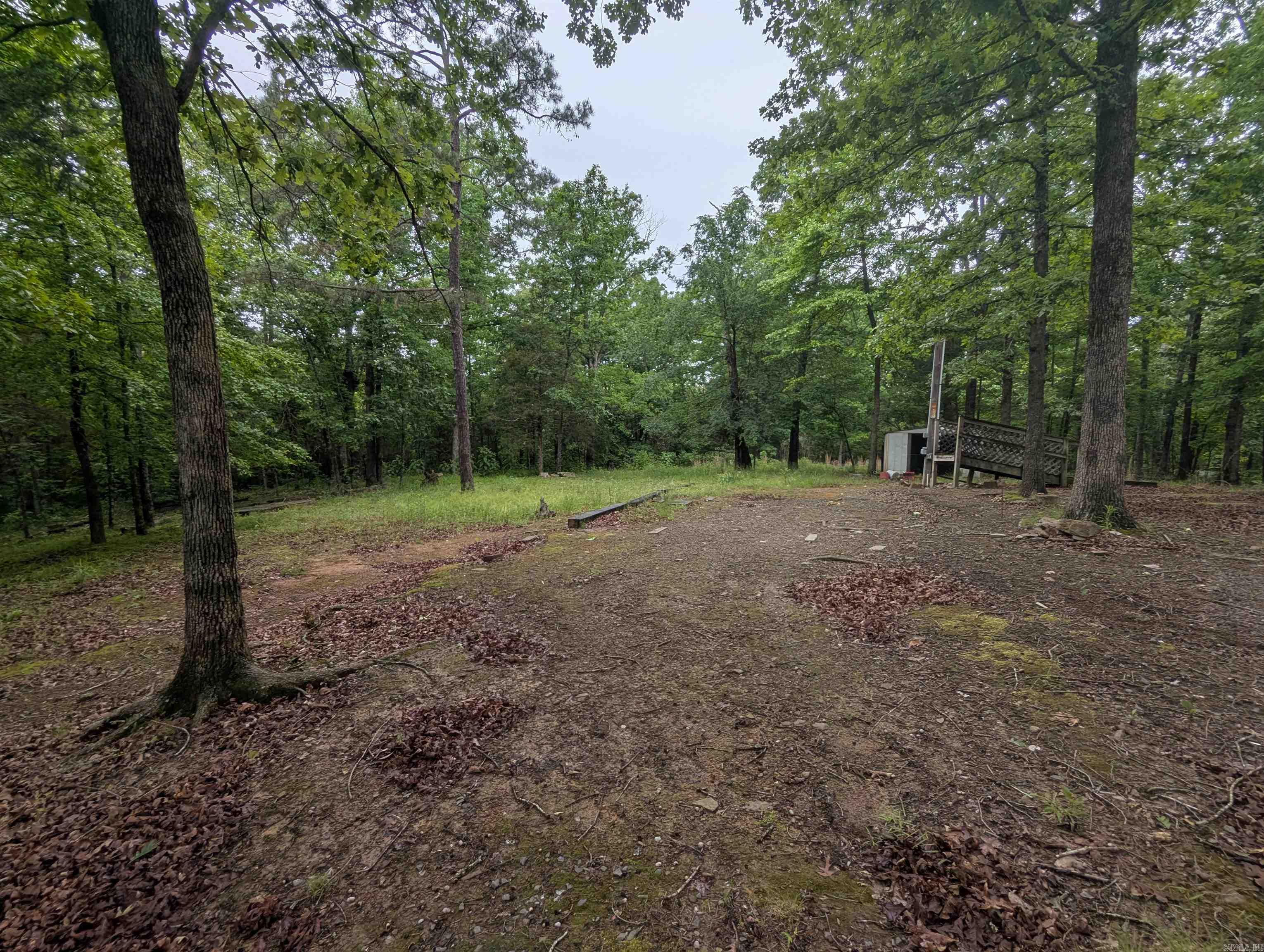 This 2.5 acre lot has been used as a vacation spot for camper.  It has county water, septic sewer and electric on site with a current 50 amp service connection.  Tree covered and very shady.  A couple of wet weather creeks, large trees and very quite neighborhood.