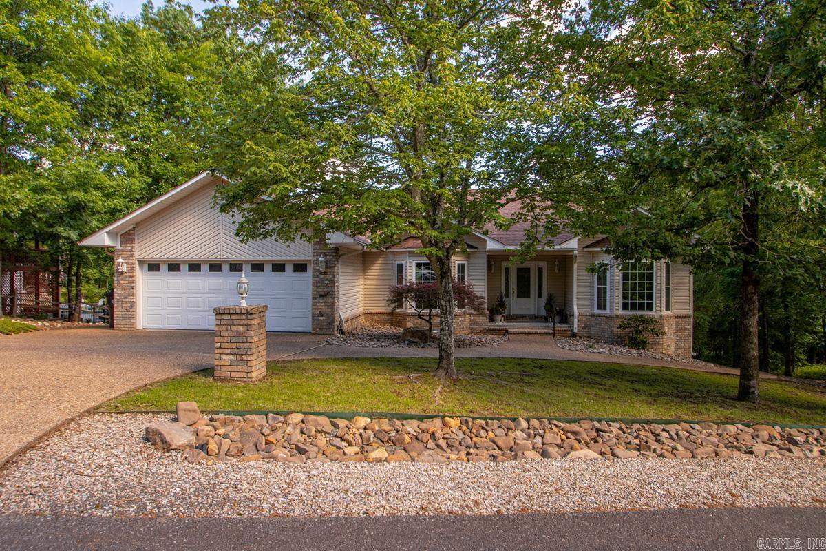Enjoy golf course living in the heart of Hot Springs Village! This well-maintained home features a desirable split floor plan and spacious living areas with amazing natural light are designed for both comfort and entertaining. The oversized primary suite offers a large ensuite bath with dual vanities, tub, separate shower, walk-in-closet and pass-through hamper to the laundry room. The kitchen and main living spaces flow seamlessly to the back deck and beautiful views — perfect for morning coffee or relaxing evenings overlooking the 8th green of Balboa Golf Course. Additional highlights include a 2-car garage plus a walkout basement/crawl space with ample room for storage, workshop and your golf cart. Convenient location with easy access to two village gates and amenities. Agents see remarks.