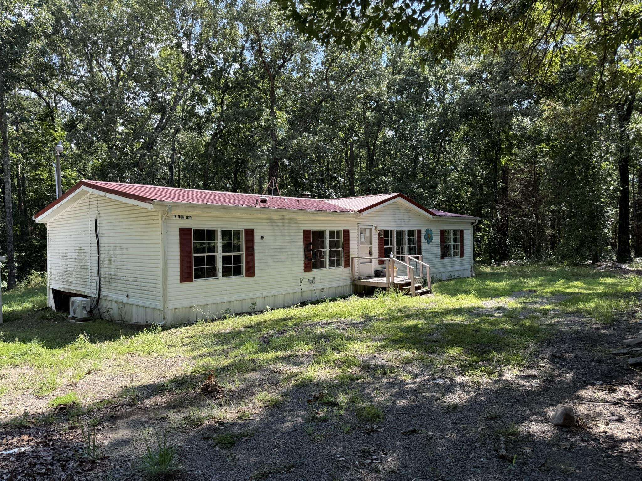 3 Bedroom Manufactured Home Near Greers Ferry Lake This 3-bedroom, 2-bathroom manufactured home is situated on a secluded 1-acre lot in the Greers Ferry area. The property is ready for renovation and offers an opportunity for use as a primary residence, vacation home, rental property, or investment project. The home features a large back deck and newly installed mini-split heating and cooling systems for efficient year-round comfort. Located approximately one mile from Shiloh Marina and public swimming areas on Greers Ferry Lake, the property provides convenient access to boating, fishing, swimming, and other outdoor recreation. Local amenities are within walking distance or a short drive, offering convenient access to shopping, dining, and services in Greers Ferry. Listed for $85,000.