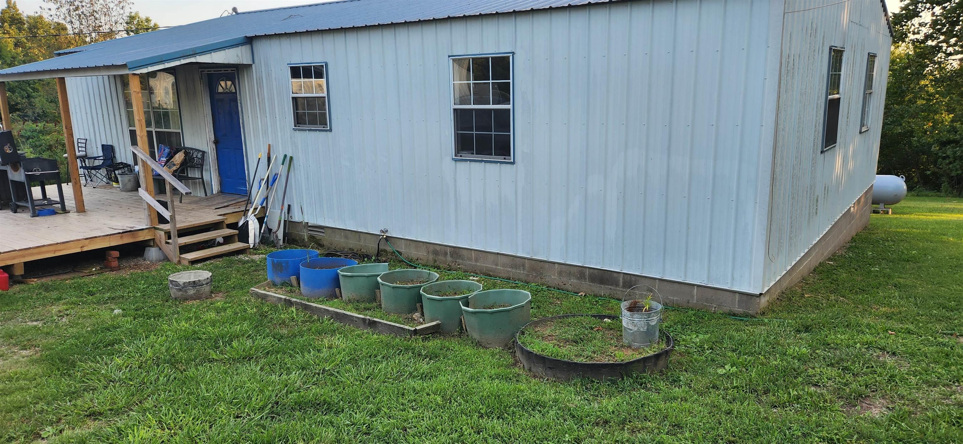 Residential Home AND Commercial Buildings. Flexible live-work-invest INCOME POTENTIAL! Prime mixed-use property. Home: 1288 sqft, 2 bedrooms, 1.5 baths, metal roof, back porch with view - Ideal for on-site living, rental income, or office conversion. Commercial Buildings: 6168 sqft, main 100'x54' structure with 6'x48' addition for expanded operations, storage, and suitable for retail, service business, workshop, event venue, or multi-use commercial purposes.  Storage unit facility: 2000 sqft, 4 units at 10'x20' each and 3 double units. Key Advantages: High demand due to strong tourist-driven traffic in the Spring River area and local housing needs, high-visibility highway frontage. Possible campground attraction. Outdoor attractions include hiking, fishing, canoeing, kayaking, nearby lakes, and Ozark mountain views. Priced to sell, as it needs some "fixing up". See separate listing for more information on the included commercial buildings. (some wide angle photography used)