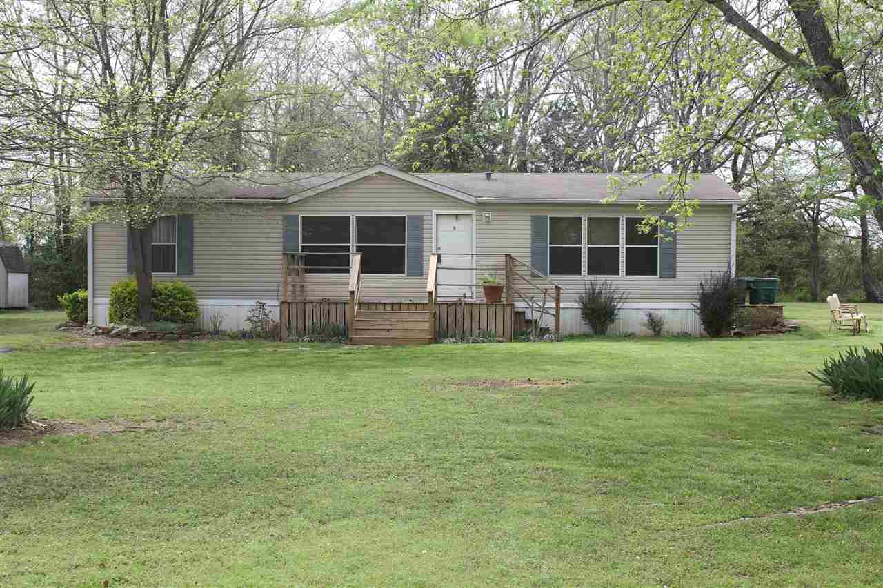 Beautifully maintained 28 x 48 double-wide mobile home on a permanent foundation. Home is located on 2 oversized lots and you will love the well-manicured yard with abundant shade trees. This home qualifies for financing and boasts 3 bedrooms, 2 baths with all new light fixtures and fans, newer carpet, huge living room and kitchen with island & breakfast bar, and large soaking tub in master bath. Area is quiet with minimal traffic and the driveway is paved. Close to schools, shopping, dining and interstate.