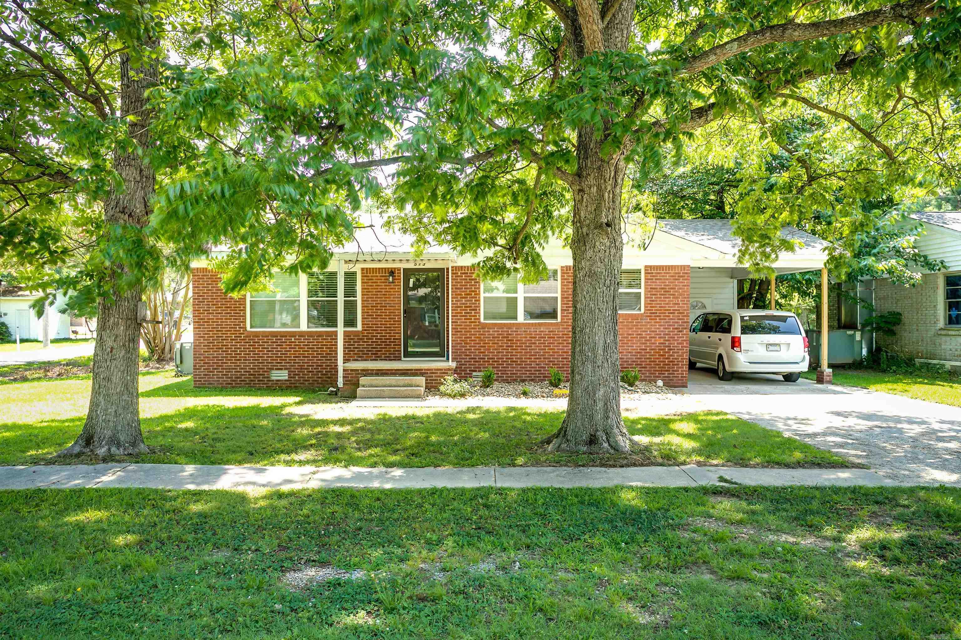 Welcome to 513 N 7th Street!!  Some homes just feel welcoming the moment you pull into the driveway… and this is one of them.  This beautifully remodeled 3-bedroom, 1-bath all-brick home offers 1,042 square feet of thoughtfully updated living space. From the restored original hardwood floors to the gorgeous tile in the kitchen and bathroom, every detail reflects quality craftsmanship.  The home was renovated down to new sheetrock in 2024 and has been lovingly cared for since, making it truly ready for its next owners. No projects, no "dad bring your tool box" simply READY!  Outside, you’ll find a covered carport and two beautiful mature shade trees that add both curb appeal and a relaxing outdoor setting. A spacious yard that even has a "ready to go" garden area!  Whether you’re looking for your first home, ready to go investment property, wanting to simplify into something more manageable, or simply searching for a home that’s already been updated, this one is definitely worth seeing.