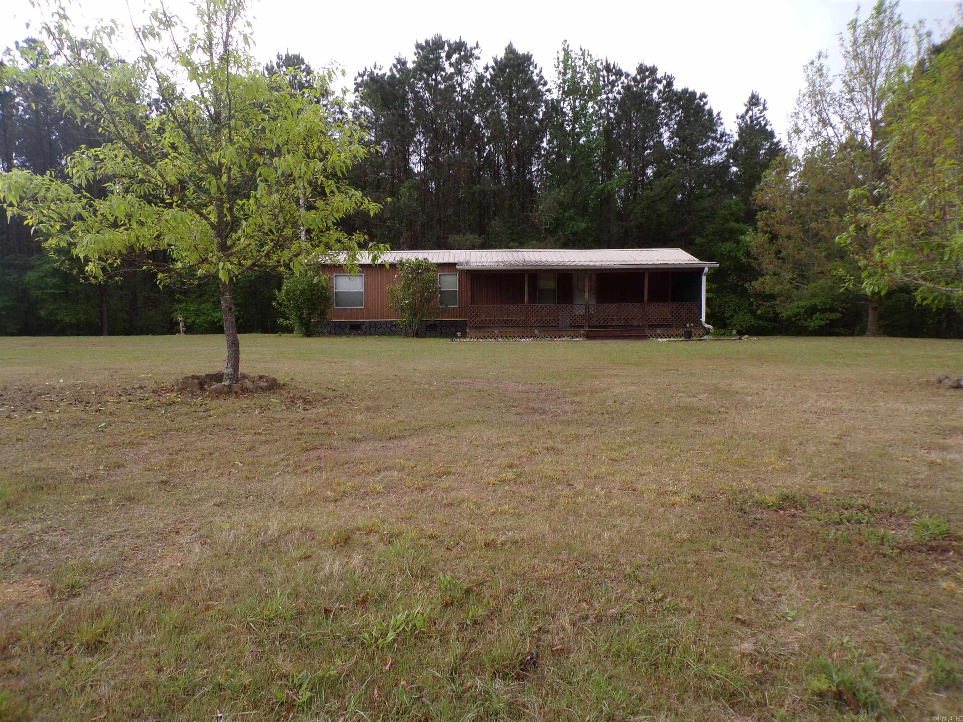 If you're looking for a place to retire or a vacation place, a place where you can be in the water on Lake DeGray at Brushy, Alpine Ridge, or Ozan Point Recreation areas within 10 min...this is it!  Nice solid MH on a 3 +/- acre lot with new floors, 2 mini splits, 2 vent free infra red heaters, large screened in porch across front, Nice 28X36 shop seller used to house their Pontoon Barge and Bass Boat with plenty of room. Home has a septic tank with new plumbing. Also new plumbing in MH. Sellers have used for a get away for over 20 years but getting older and no longer using enough. This property won't last long !