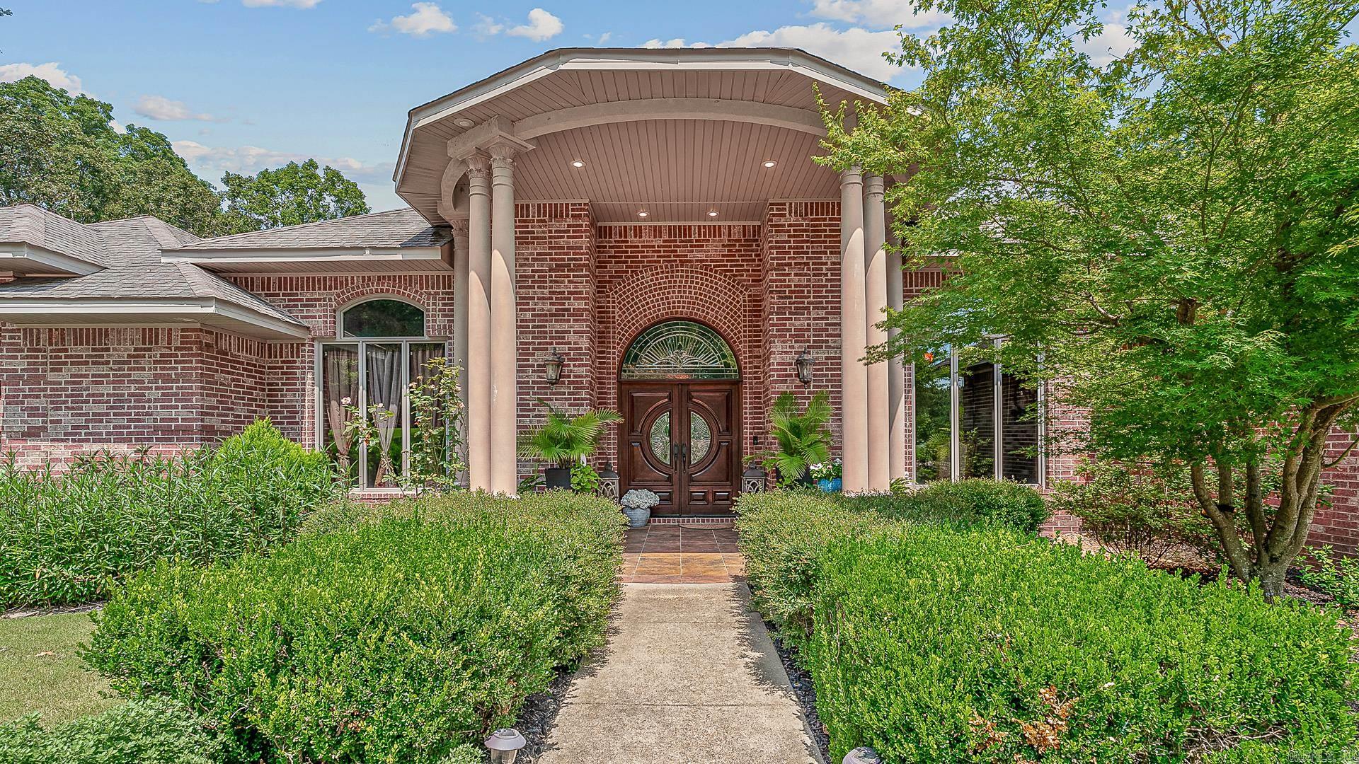 Oasis in the Outback A truly one-of-a-kind luxury estate where timeless architecture meets resort-style living. Spanning approximately 8,000 square feet on more than 1.5 beautifully landscaped acres in the highly sought-after **Valley View School District**, this extraordinary home offers an unmatched blend of elegance, comfort, and entertainment. Inside, a formal dining room with an electric fireplace sets the tone before opening to the chef's kitchen, complete with a gas range, wall oven, ice maker with filtration system, expansive walk-in pantry, and abundant workspace. The kitchen flows seamlessly into the inviting hearth room, where a gas fireplace and custom built-ins create the perfect gathering space. Step outside to expansive upper and lower patios, each featuring a wood-burning fireplace and overlooking the spectacular 28,000-gallon saltwater pool with cascading waterfallan outdoor retreat designed for year-round enjoyment.