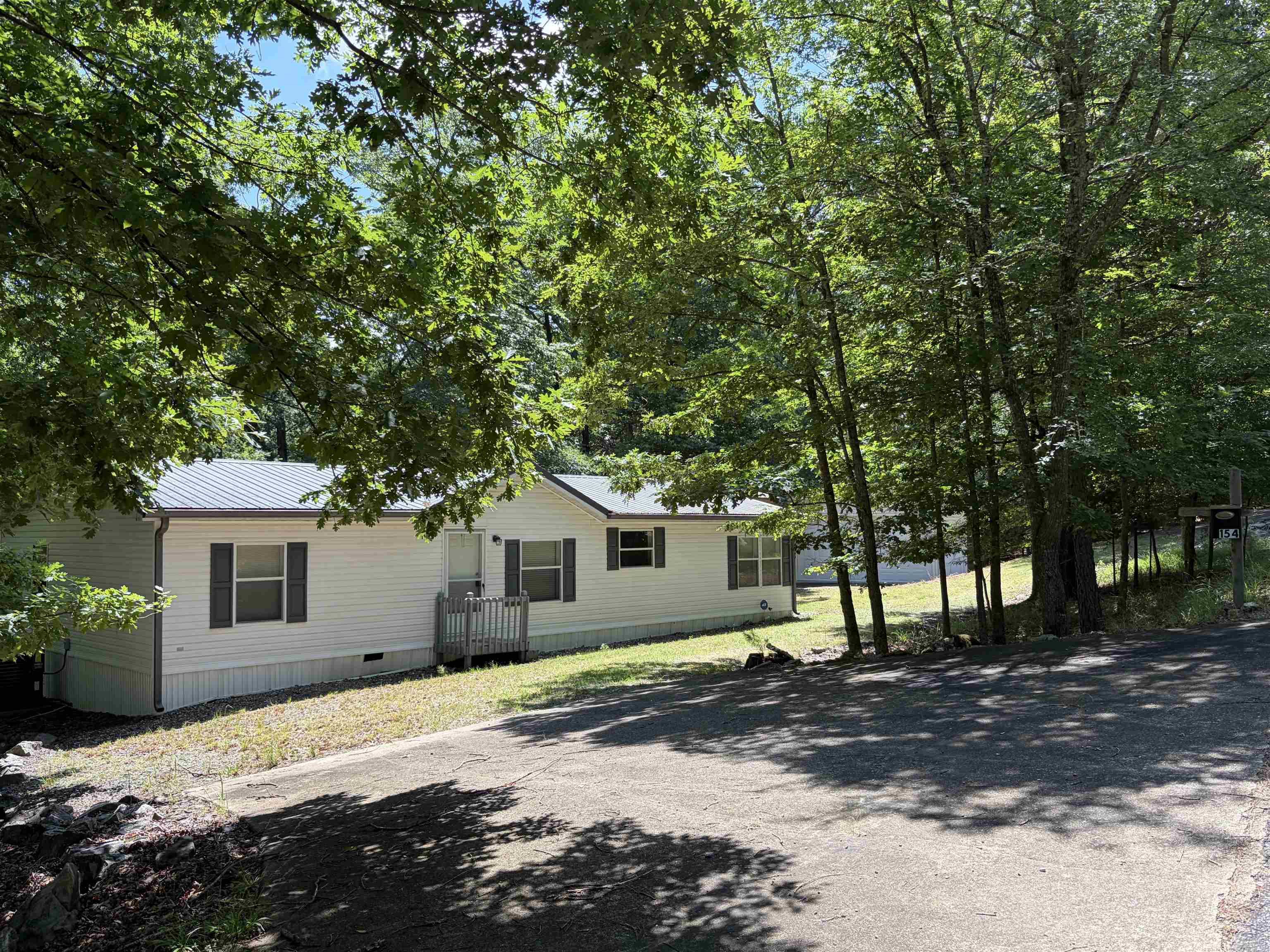 3 bedrooms, 2 baths, approx. 1,568 sq ft, mobile home located in the Harbor South subdivision at Mountain Harbor Resort on beautiful Lake Ouachita.  This property offers comfortable lake area living with a screened back deck and a large open deck, providing excellent outdoor entertaining and relaxation space.  Additional features include a 26' x 33' garage with plenty of room for the side by side and all the necessary lake things, a whole-home generator, circular driveway offering easy in and out and parking and granite kitchen countertops.  Located just minutes from the Harbor South Park, Mountain Harbor Marina and the Vista Trail.  Call today for your private showing and start enjoying all the outdoor adventures that Lake Ouachita has to offer.