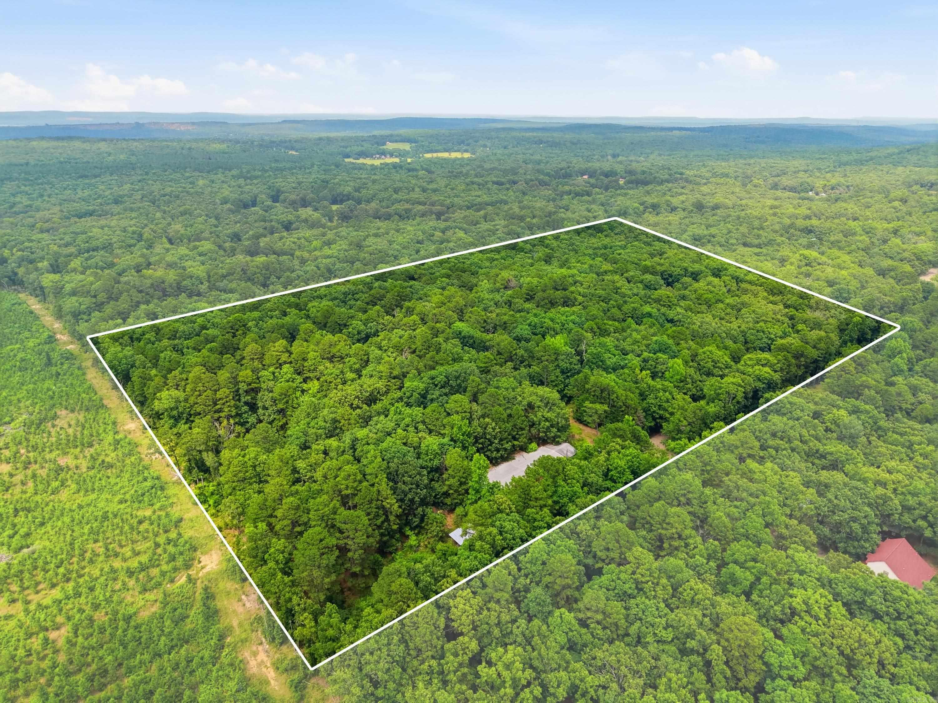 Discover the possibilities on this beautiful 10-acre property featuring level, wooded land that offers the perfect balance of privacy and opportunity. Whether you're dreaming of a secluded homesite, a multi-generational homestead, or an investment property, this acreage is ready for your vision. Build your dream home and take advantage of the opportunity to build up for stunning Wye Mountain views that are sure to impress. Utilities are already in place with two electrical service points, city water, an existing septic system, and an old well. A peaceful pond adds to the property's natural beauty. The existing 3,752 sq. ft. building sits on a concrete slab and, with a little TLC, could become a comfortable residence, an incredible workshop, or both. Previously occupied, the building includes a 4-ton HVAC unit with ductwork already installed. Fiber internet is nearby, making country living even more convenient. Located at the end of a dead-end road maintained by the county, you'll enjoy privacy without sacrificing accessibility. Appointment required. See Agent Remarks for additional information.