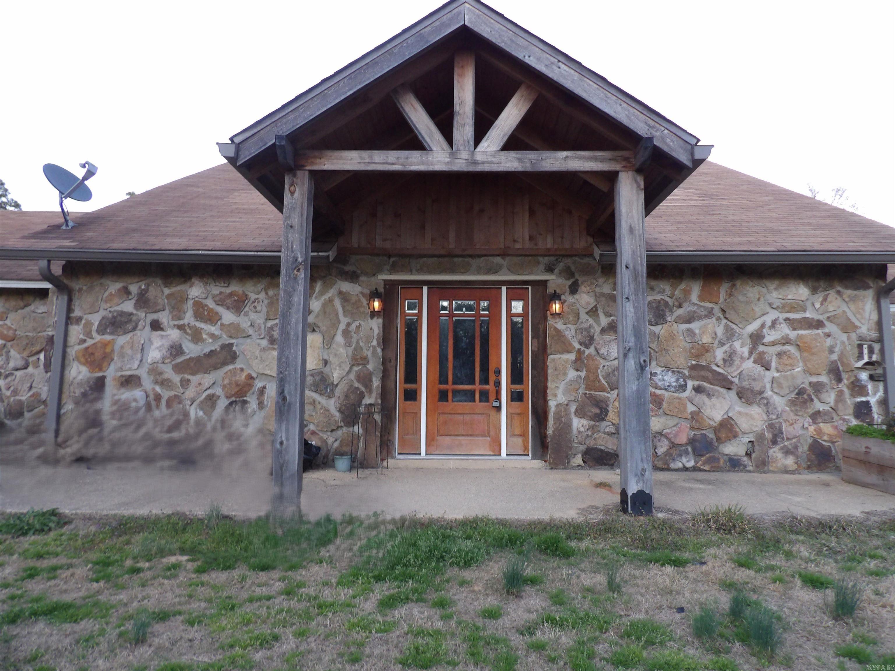 This beautiful home features natural Arkansas stone siding and offers 3 bedrooms, 2 full baths, and a dedicated office area. The spacious kitchen provides abundant dining space, an in-kitchen bar, and plenty of room for gathering. You’ll enjoy both a formal living area and a large den highlighted by a striking stone fireplace. The property includes a nice 30×30 shop with a 16-ft side shed, perfect for equipment, hobbies, or extra storage. A peaceful pond sits at the front of the property, adding charm and curb appeal, while a back balcony gives you a relaxing place to unwind and take in the wooded views. All of this sits on over four acres of rolling hillside, offering privacy, and the feel of true country living.