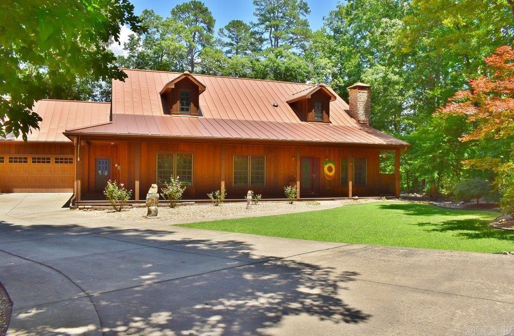 Beautiful custom-built cabin-style home nestled in a serene natural setting, offering complete privacy while being just minutes from the outstanding amenities of HSV. Enjoy easy access to championship golf courses, boating & fishing lakes, miles of walking trails, tennis & pickleball courts, restaurants & more. Attractive front yard with lush green landscaping welcomes you to this charming one-level home, enhanced by a country style covered deck. Inside, the inviting living room features 9-foot ceilings & a cozy fireplace, flowing seamlessly into the open-concept kitchen w/ a granite island & breakfast bar; dining area & a breakfast nook.  Thoughtfully designed primary suite includes a charming bath w/ a generous step-in shower & soaking tub, separate his-and-her vanities & a bidet. It also offers convenient direct access to the laundry room, complete w/ a utility sink & folding station. Other features include Metal Roof, 2-C+garage, storm cellar, sprinkler system, water filtration, connection f/generator... Back-porch kitchen & bar area provide the perfect space for outdoor entertaining or simply unwinding while surrounded by nature.  Come see and experience the magic of nature.